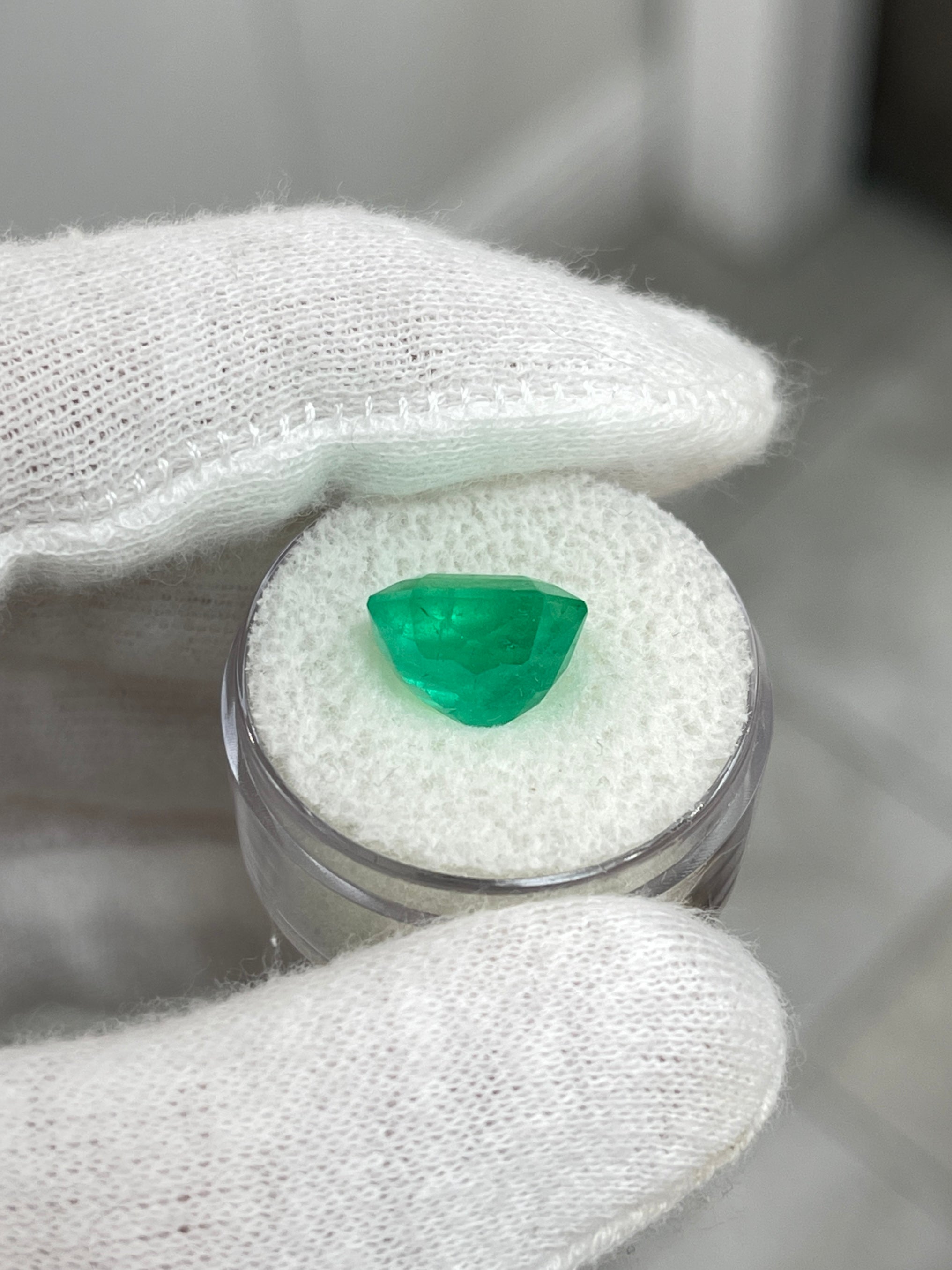 Loose 5.75 carat medium green Colombian emerald in an emerald cut with natural freckles, from JR Colombian Emeralds.
