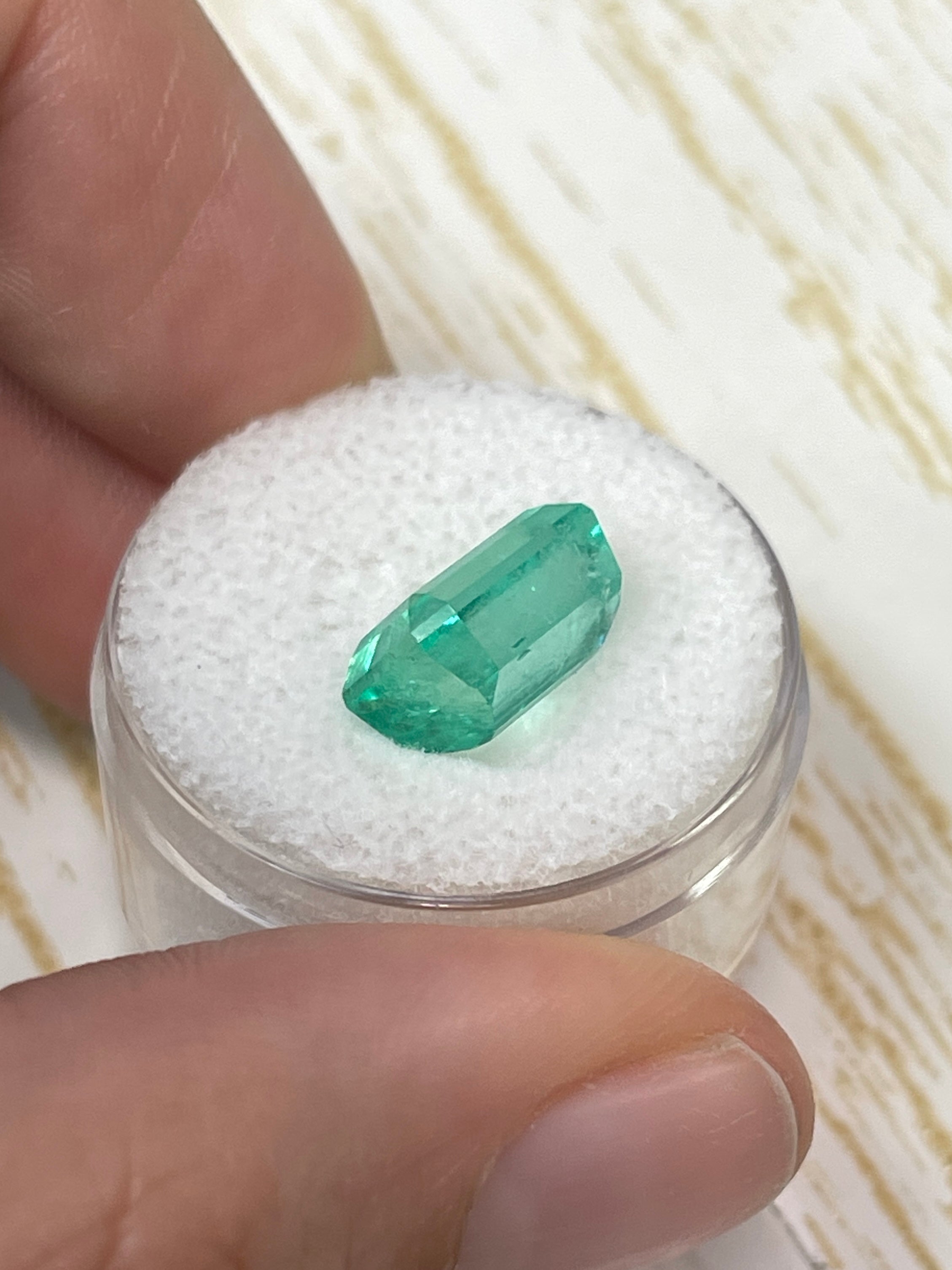 5.76 carat clear green natural Colombian emerald loose gemstone in emerald cut, showcasing vibrant color and clarity.