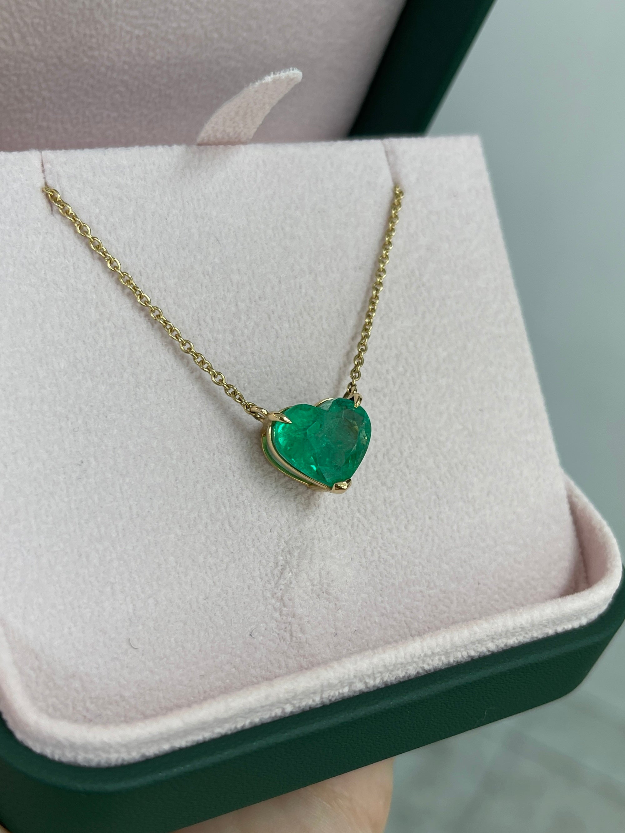 Colombian emerald heart-shaped solitaire pendant on an 18K necklace, featuring a 5.77-carat vibrant green gemstone by JR Colombian Emeralds.