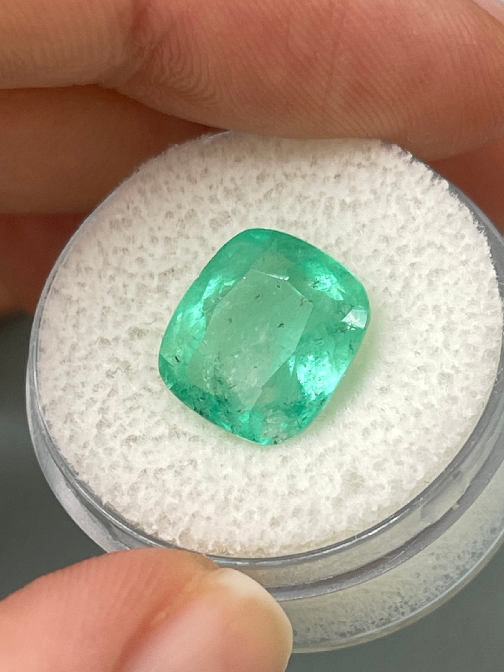 Loose 5.86 carat Colombian emerald with cushion cut, earthy pastel green color, natural gemstone from JR Colombian Emeralds