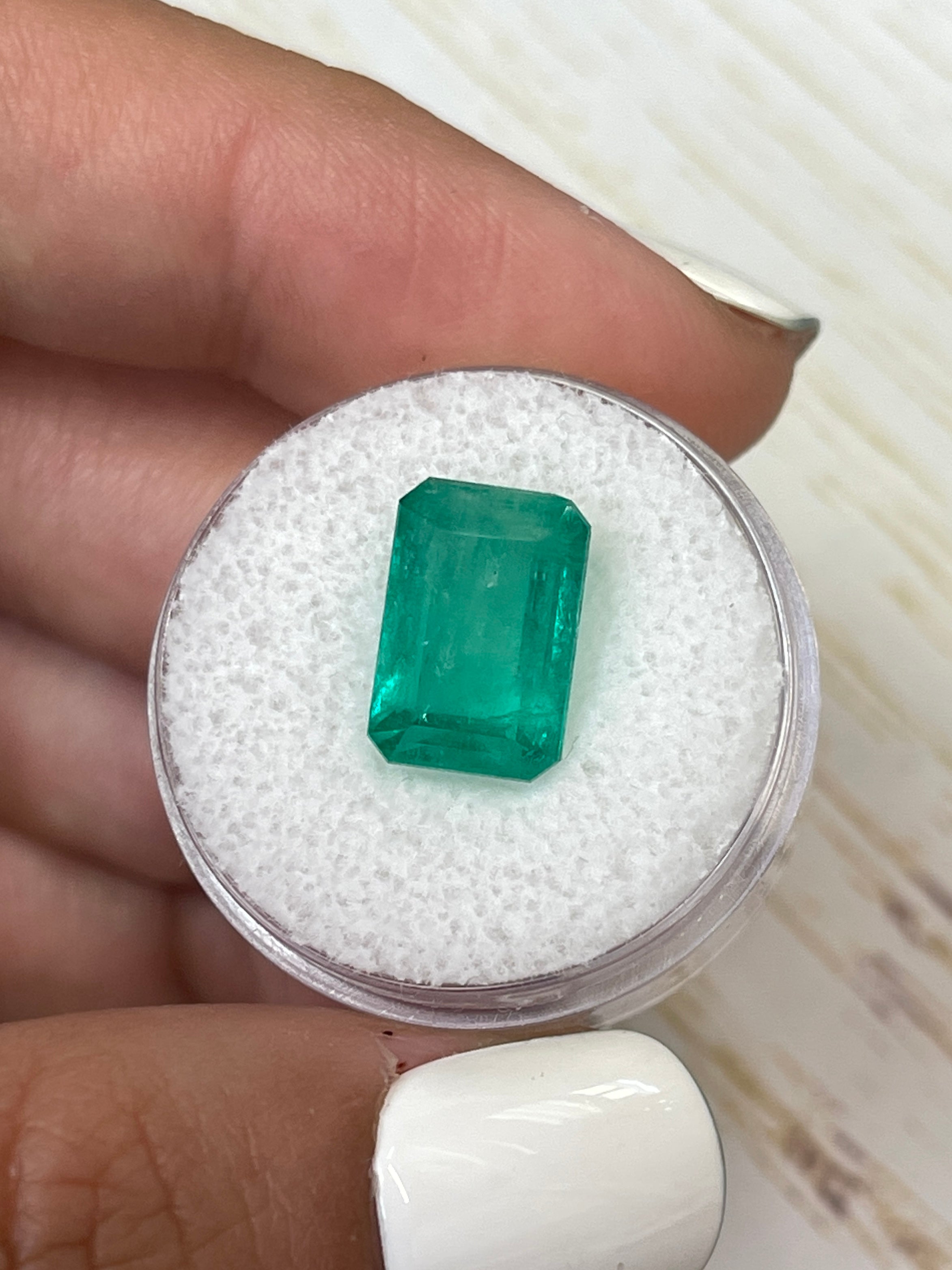 Bluish green 5.94 carat natural Colombian emerald in an emerald cut, showcasing vivid color and clarity.
