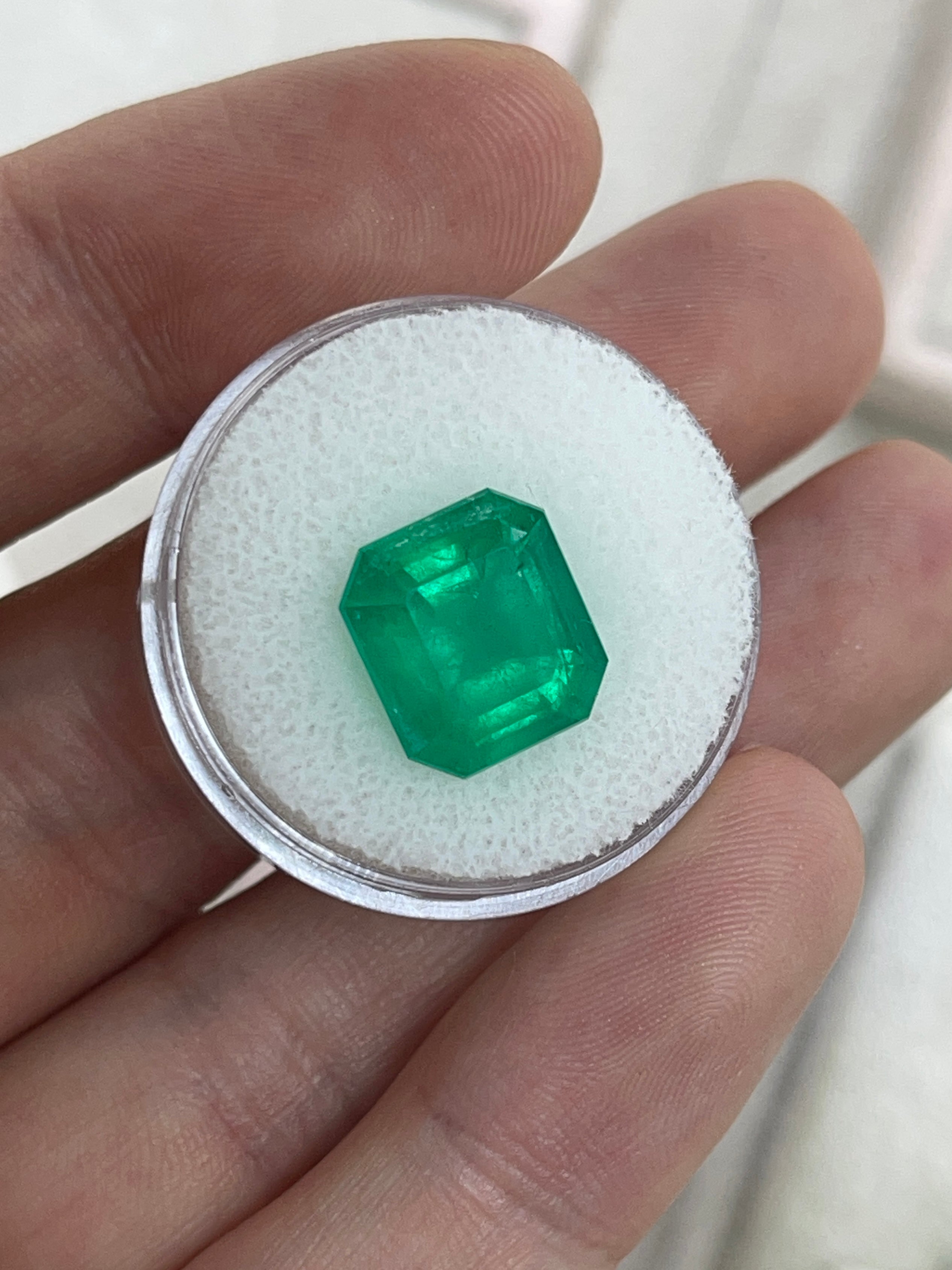 Deep green 5.94 carat Colombian emerald loose gemstone in an emerald cut, showcasing rich color and clarity.