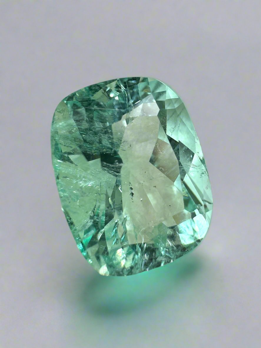 Seafoam green 5.96-carat Colombian emerald loose gemstone with natural freckles and elongated cushion cut by JR Colombian Emeralds.