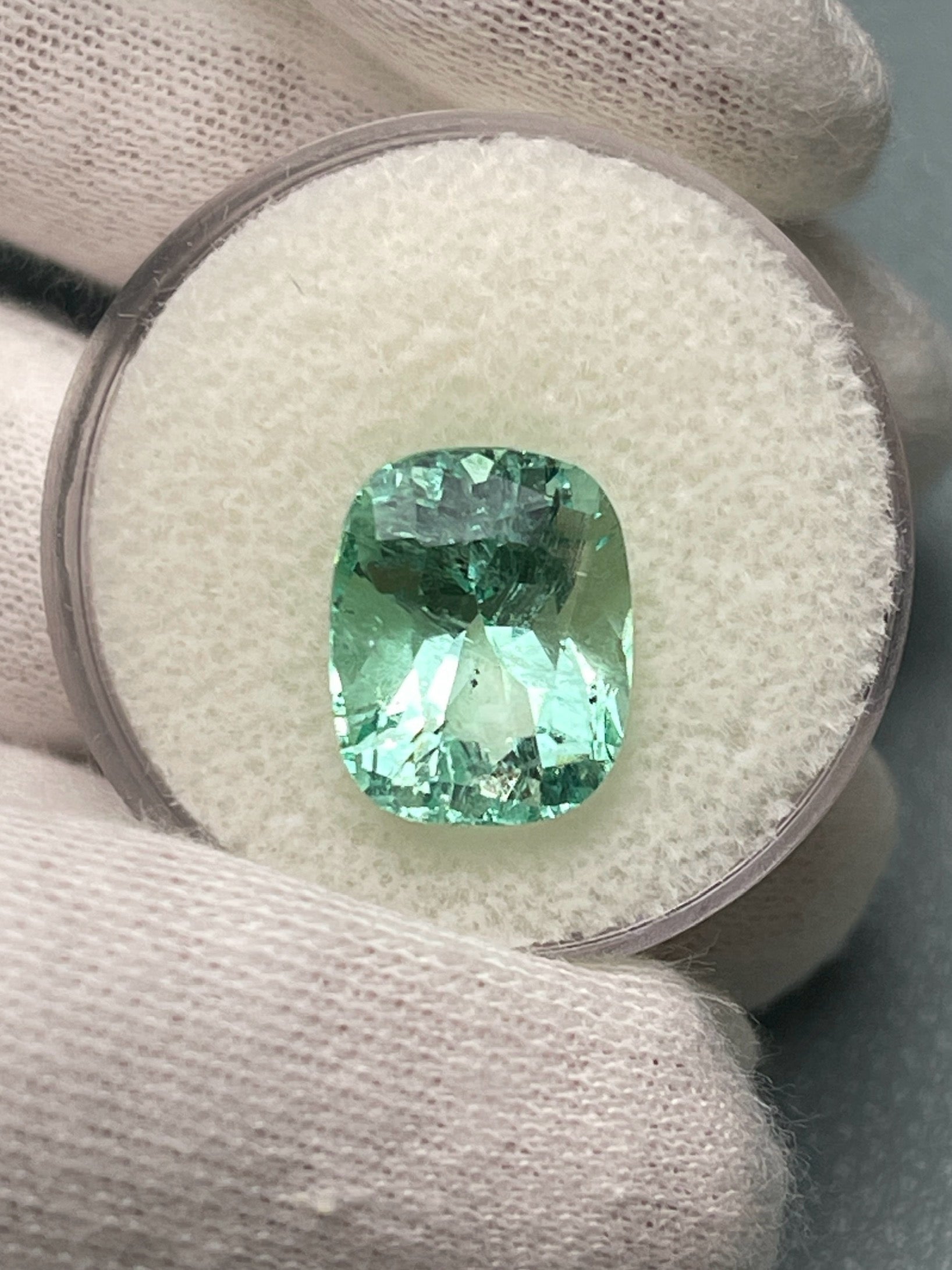 Seafoam green 5.96 carat Colombian emerald loose gemstone, elongated cushion cut with natural freckles, from JR Colombian Emeralds.