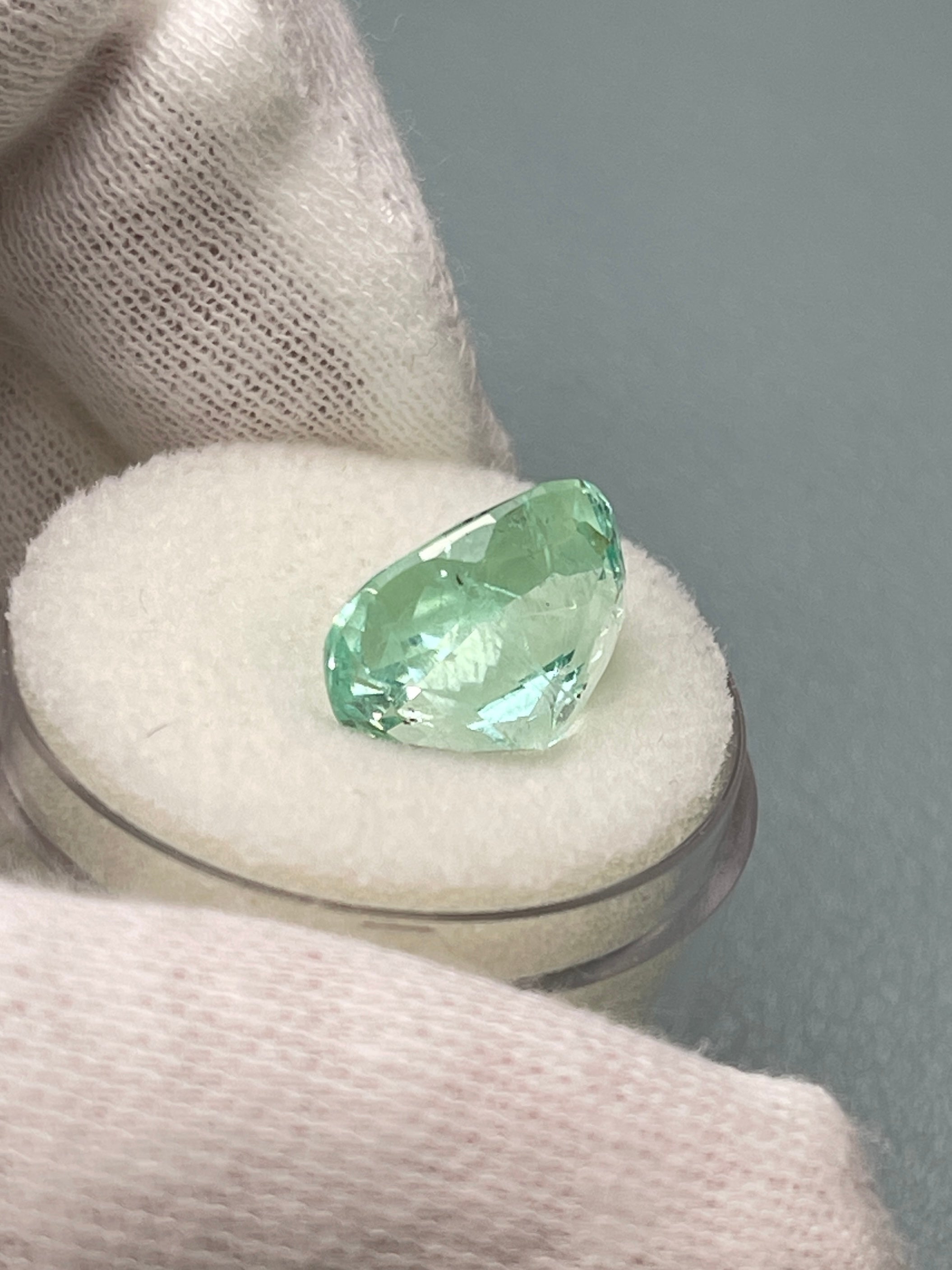 Seafoam green 5.96 carat Colombian emerald loose gemstone, elongated cushion cut with natural freckled pattern by JR Colombian Emeralds.