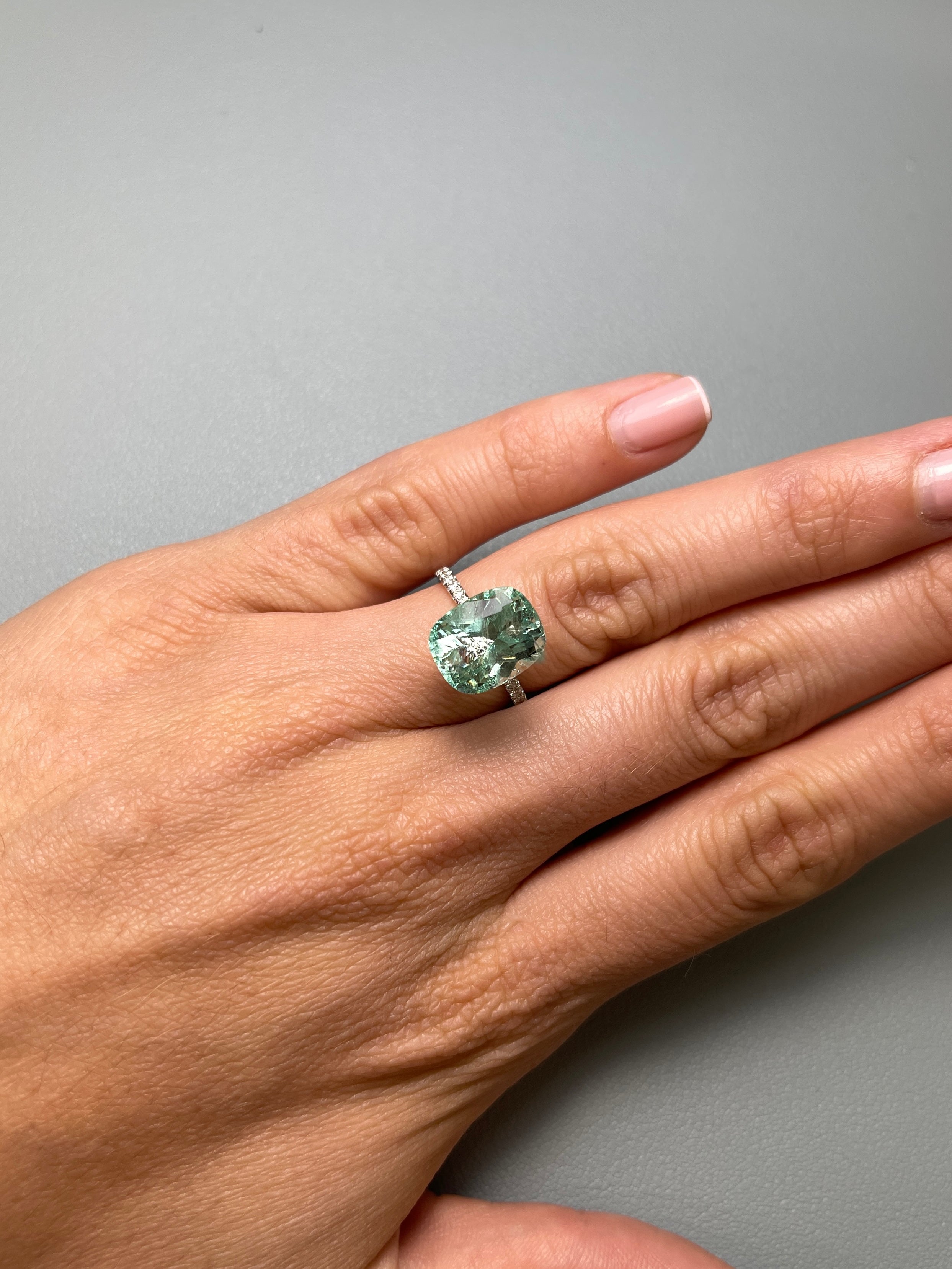 Seafoam green 5.96 carat Colombian emerald loose gemstone, elongated cushion cut with natural freckles, from JR Colombian Emeralds.