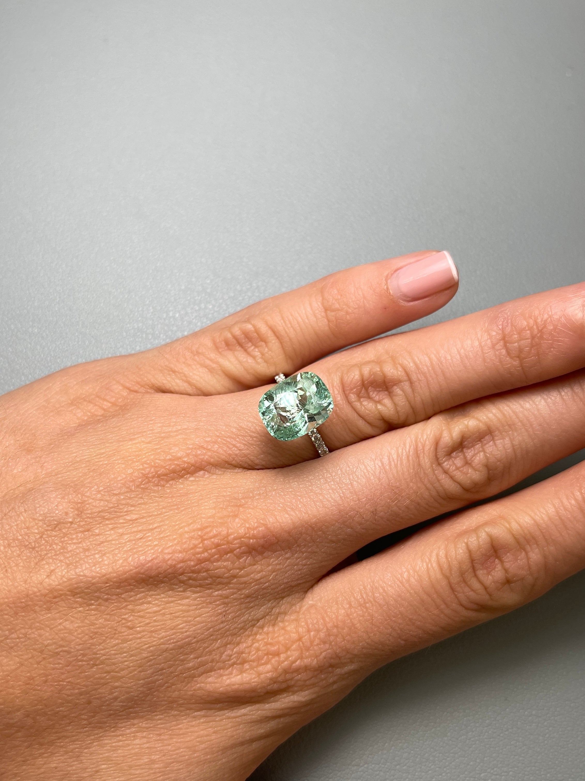 Seafoam green 5.96 carat Colombian emerald loose gemstone with natural freckles, elongated cushion cut from JR Colombian Emeralds.