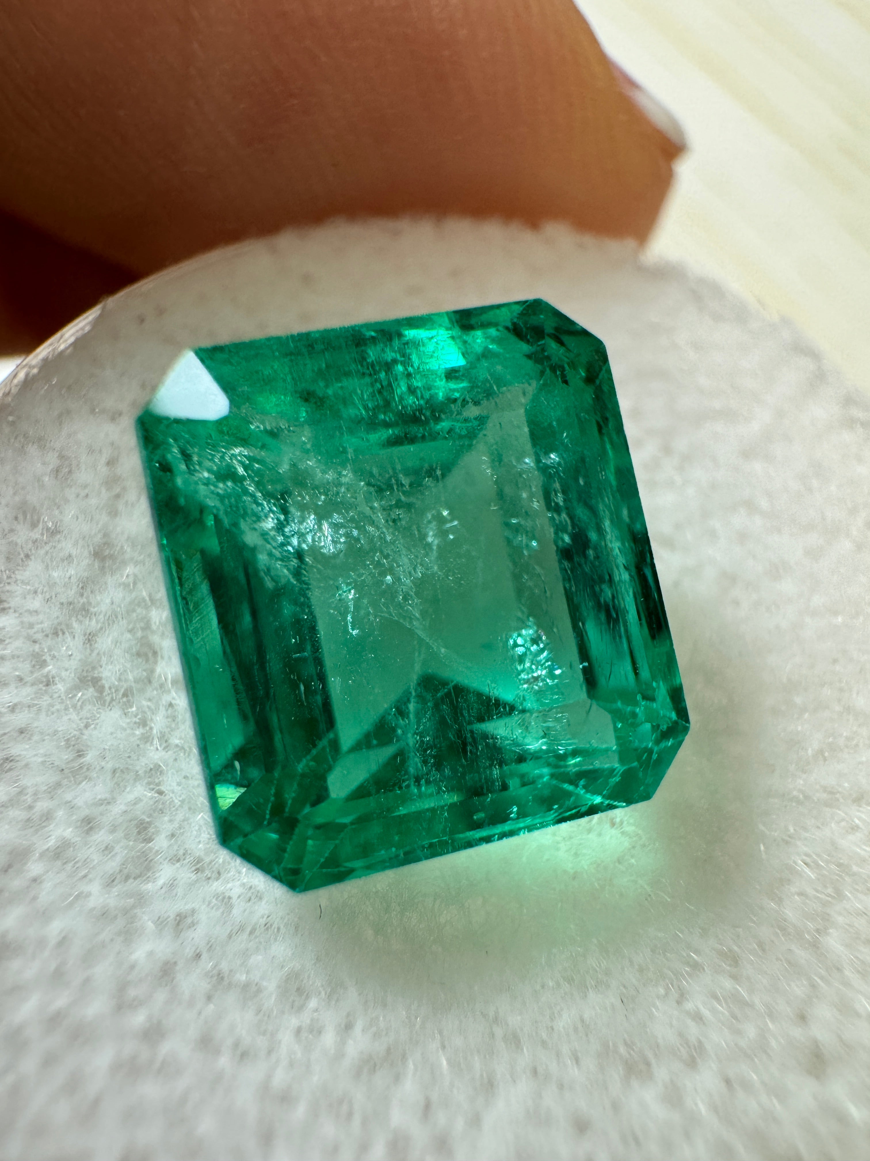 5.98 carat natural Colombian emerald loose gemstone, 10x9 emerald cut, vibrant green, crystal-clear, from JR Colombian Emeralds.