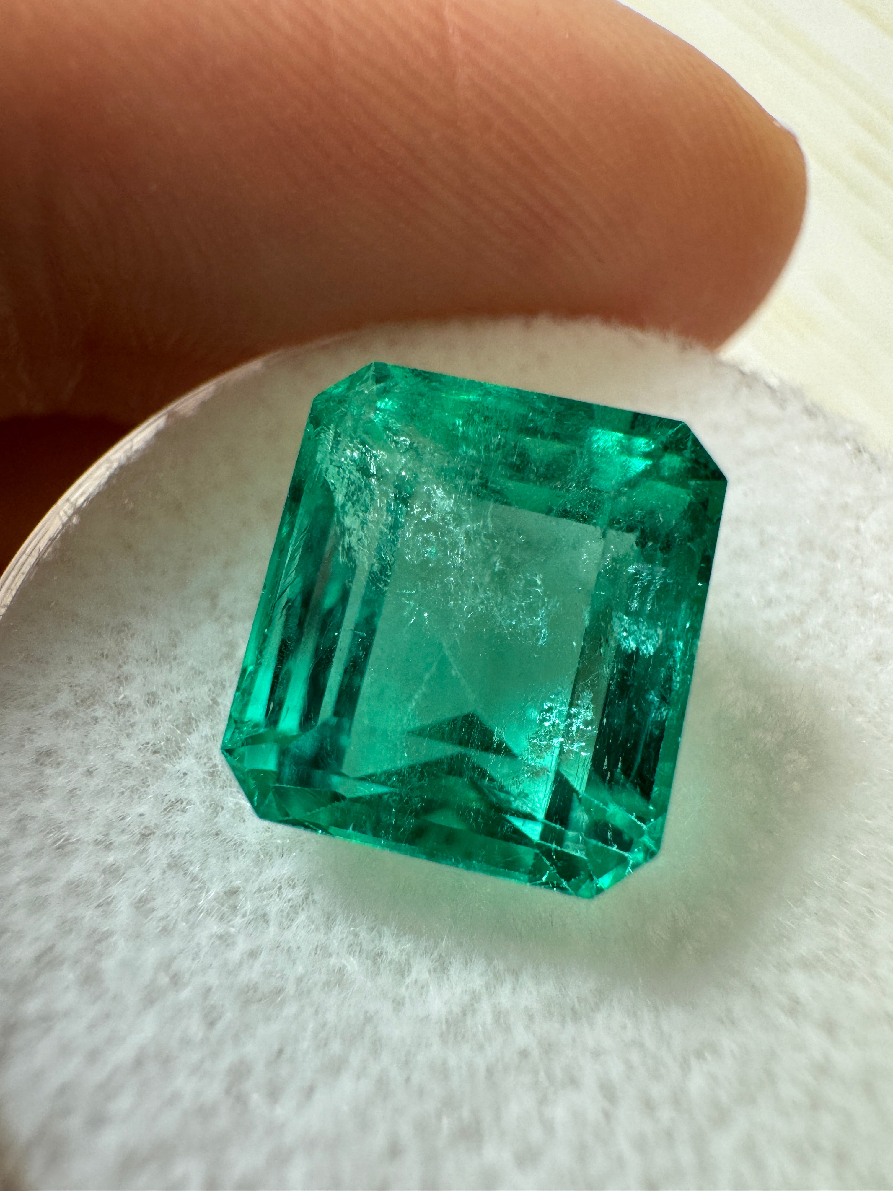 Loose 5.98 carat natural Colombian emerald in emerald cut, vibrant green with crystal clarity, from JR Colombian Emeralds.