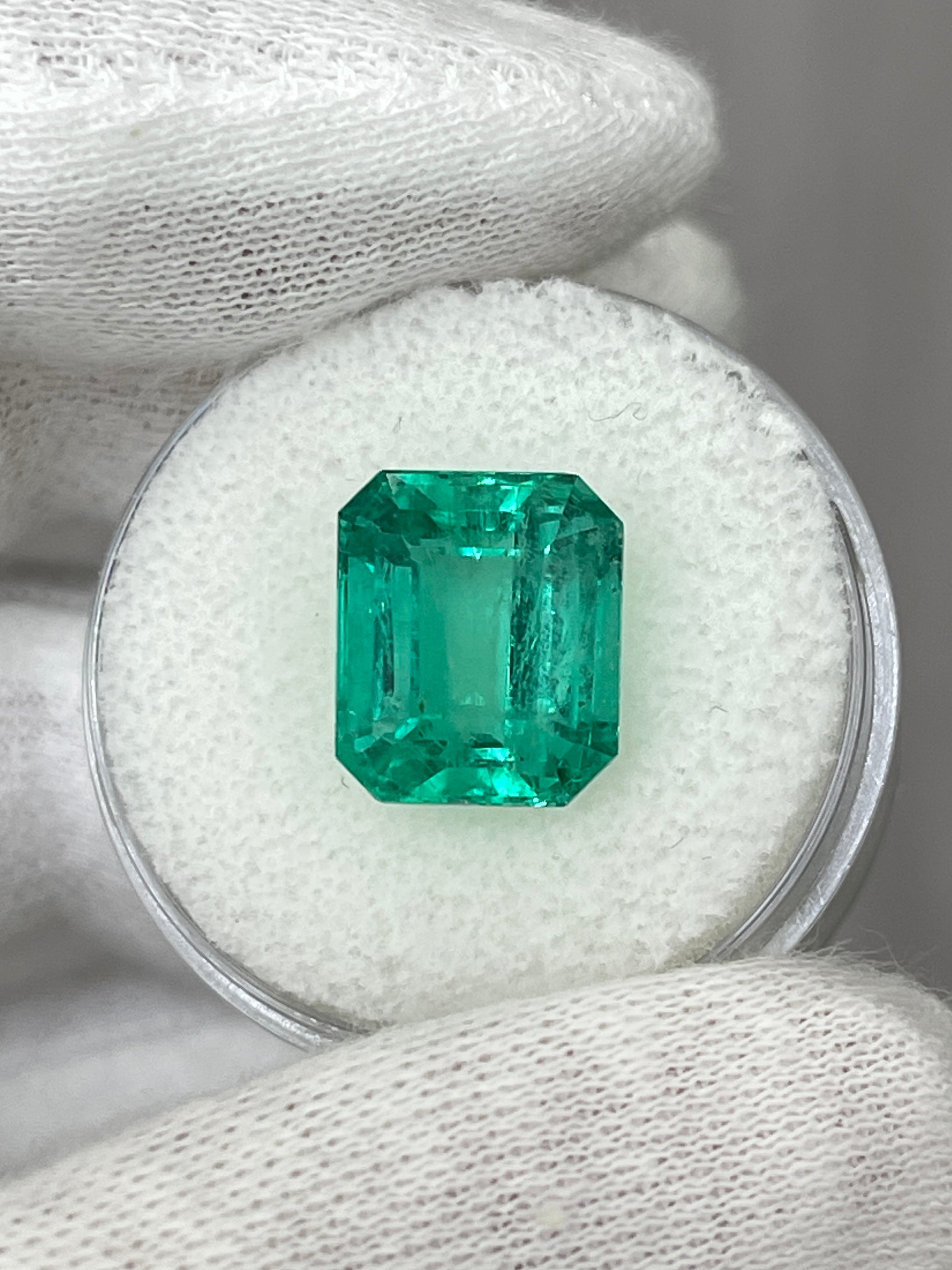 6.03 carat bluish natural Colombian emerald loose gemstone in classic emerald cut, showcasing vibrant color and clarity.