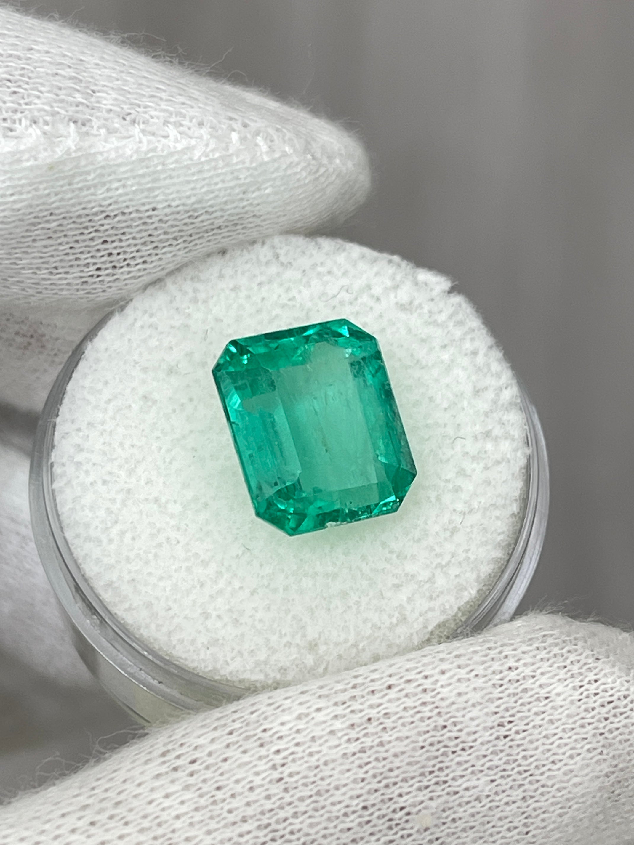 6.03 carat bluish natural Colombian emerald in classic emerald cut, loose gemstone with vibrant color and fine clarity.