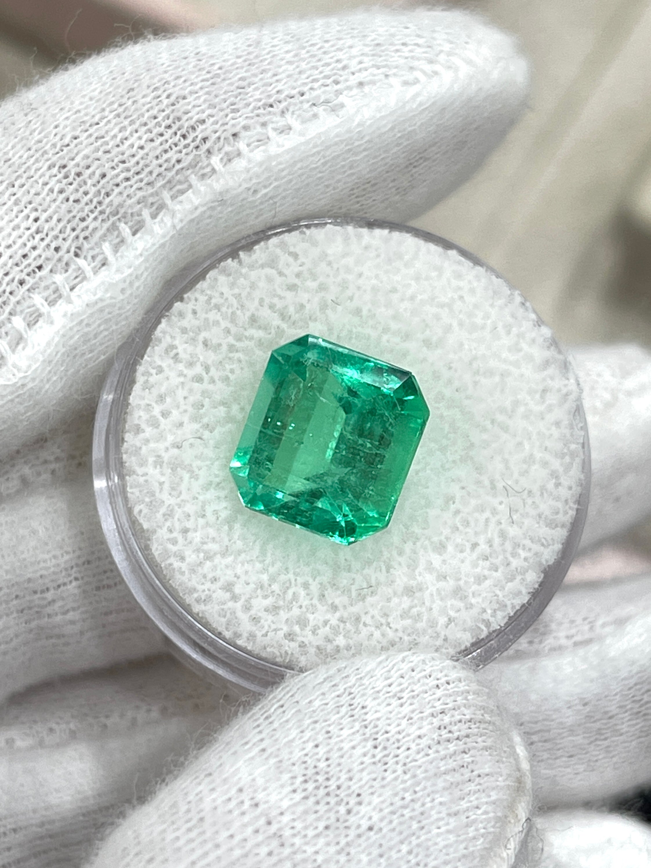 6.07 carat yellowish green natural Colombian emerald loose gemstone in Asscher cut, displayed by JR Colombian Emeralds.