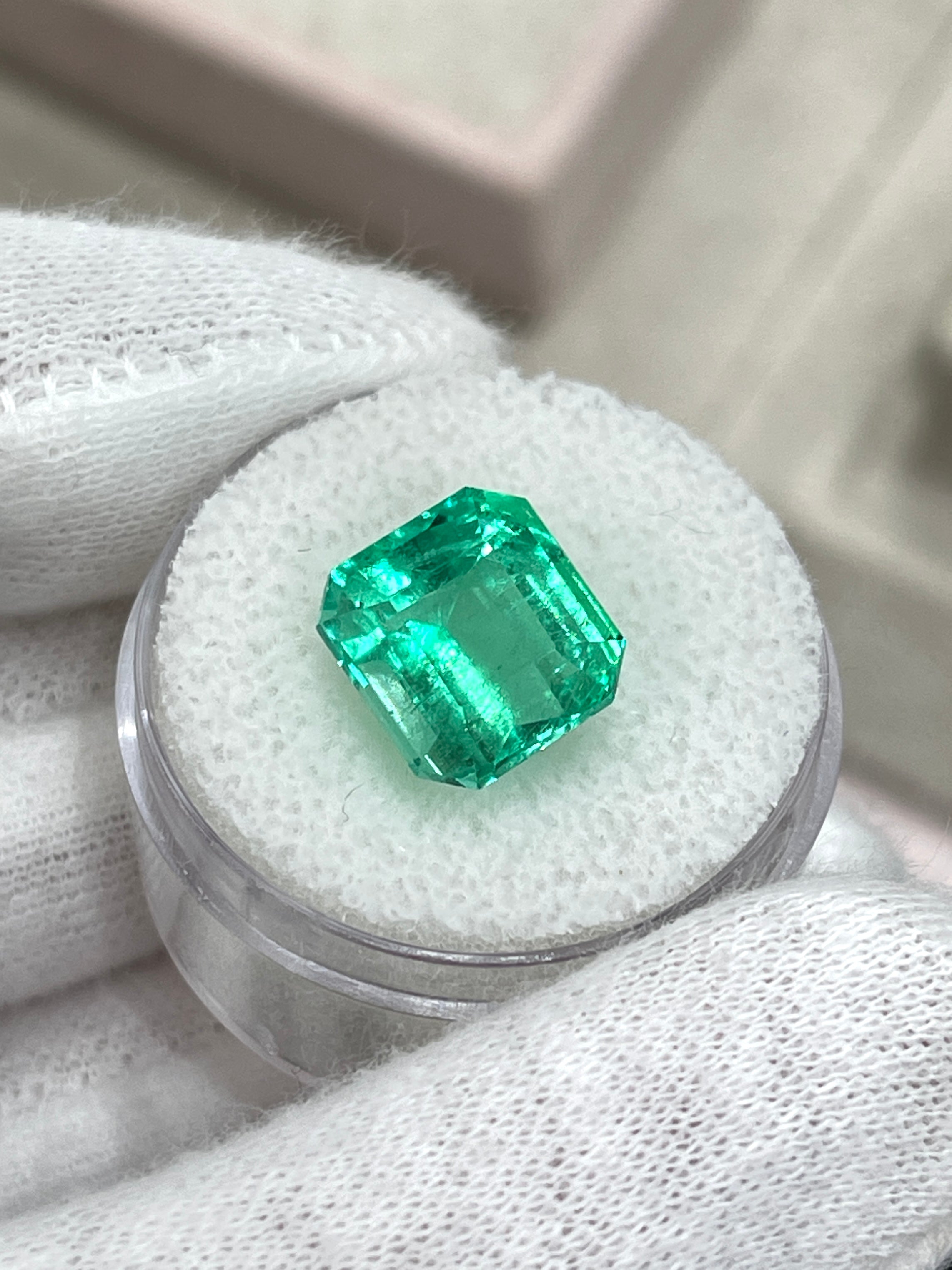 6.07 carat yellowish green natural Colombian emerald loose Asscher cut gemstone with dimensions 10.7x10 mm.