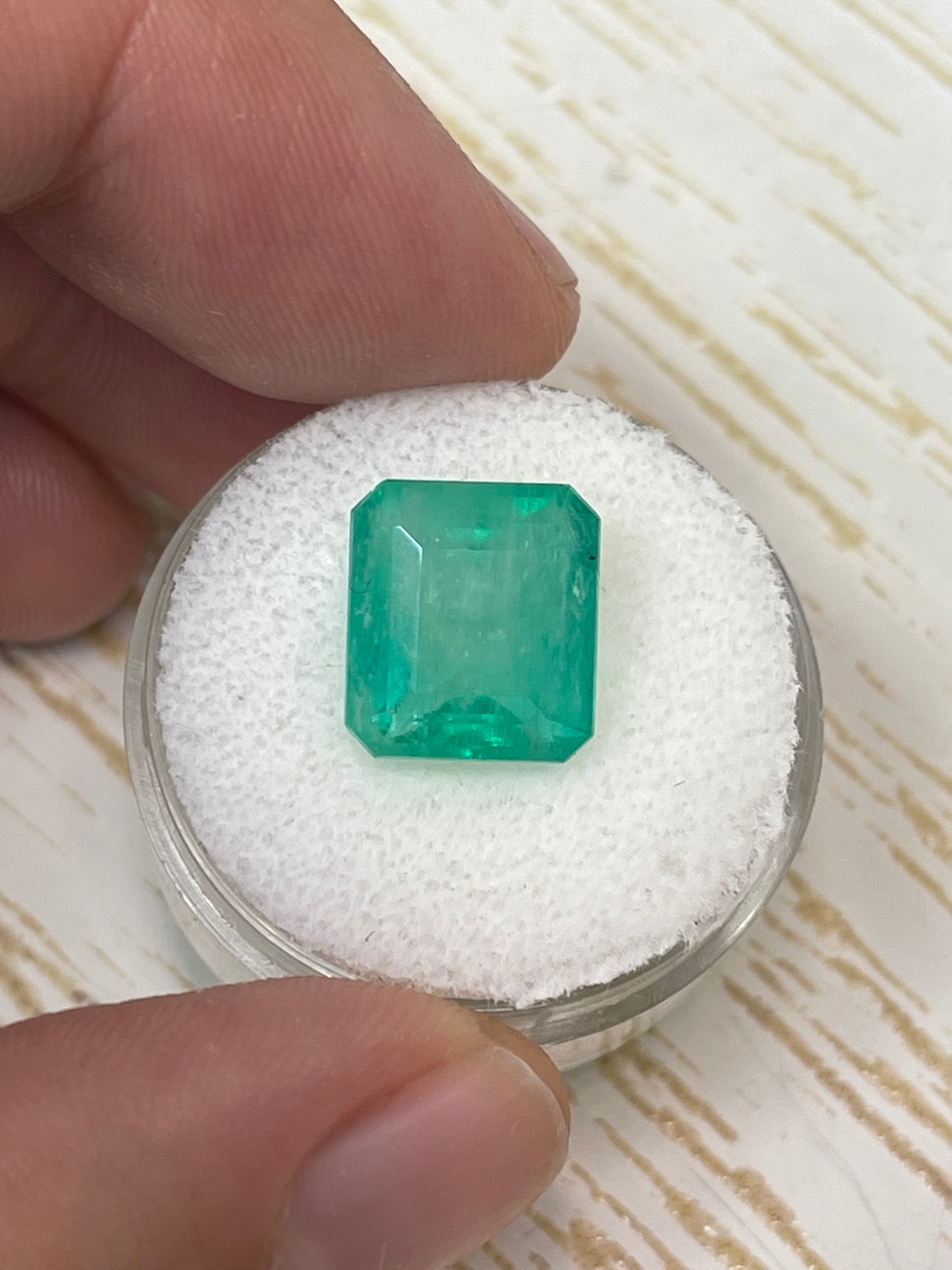 Natural loose Colombian emerald, 6.13 carats, 11.5x10.3mm, earthy pastel green, emerald cut, from JR Colombian Emeralds.