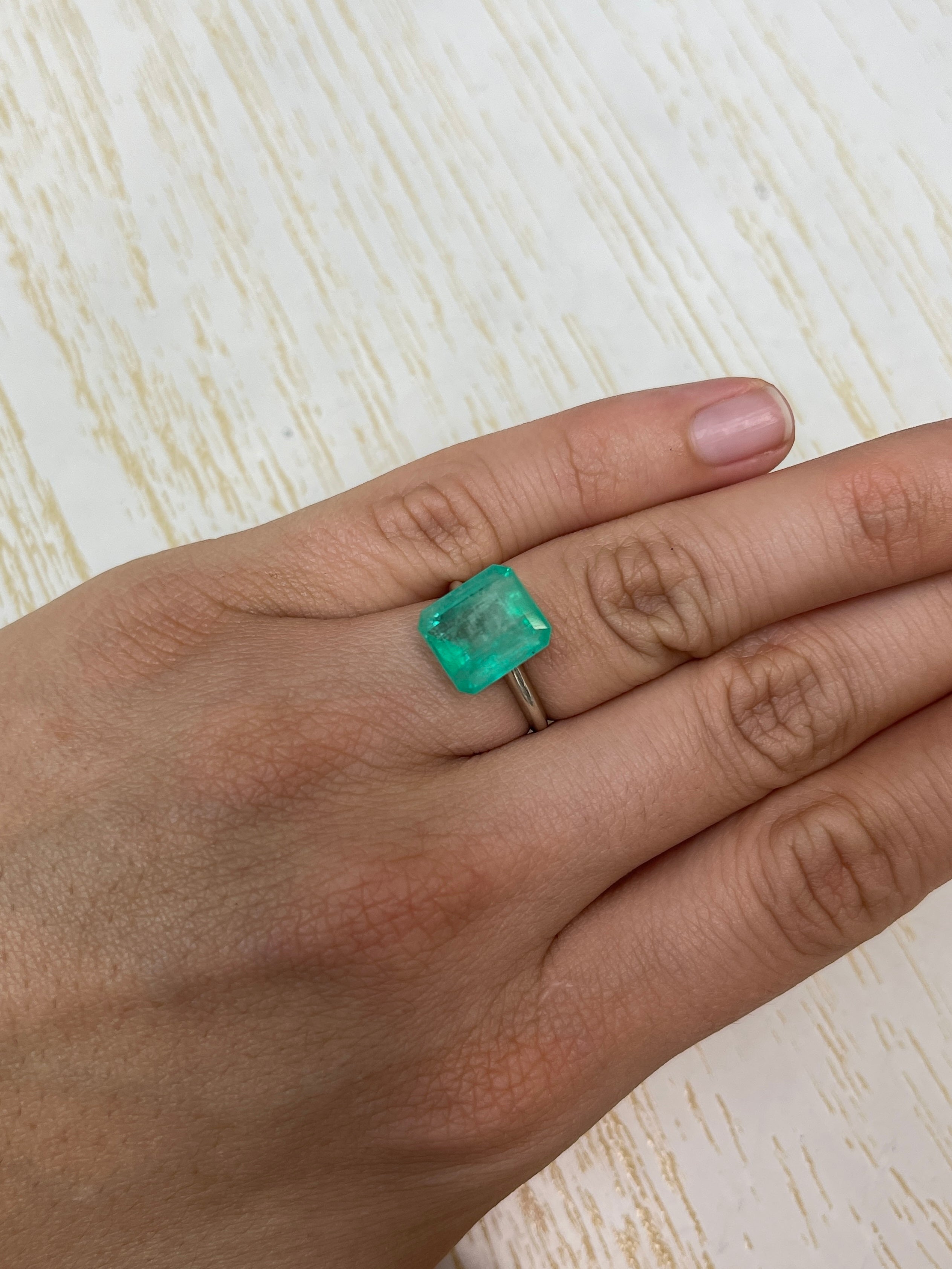6.13 carat natural Colombian emerald loose stone, emerald cut with earthy pastel green hue, from JR Colombian Emeralds.