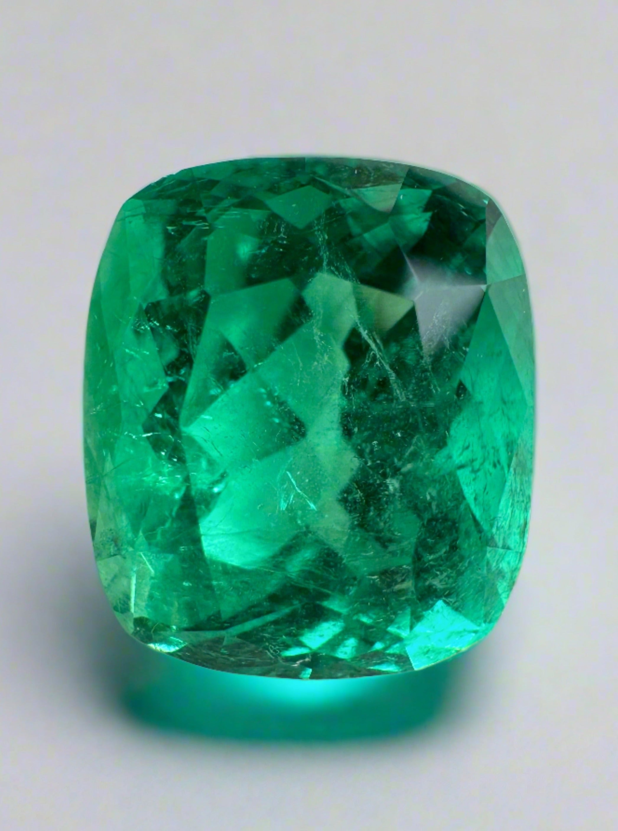 Natural Colombian emerald loose cushion cut 6.17 carats with intense green color, minor to moderate oil inclusions, from JR Colombian Emeralds.