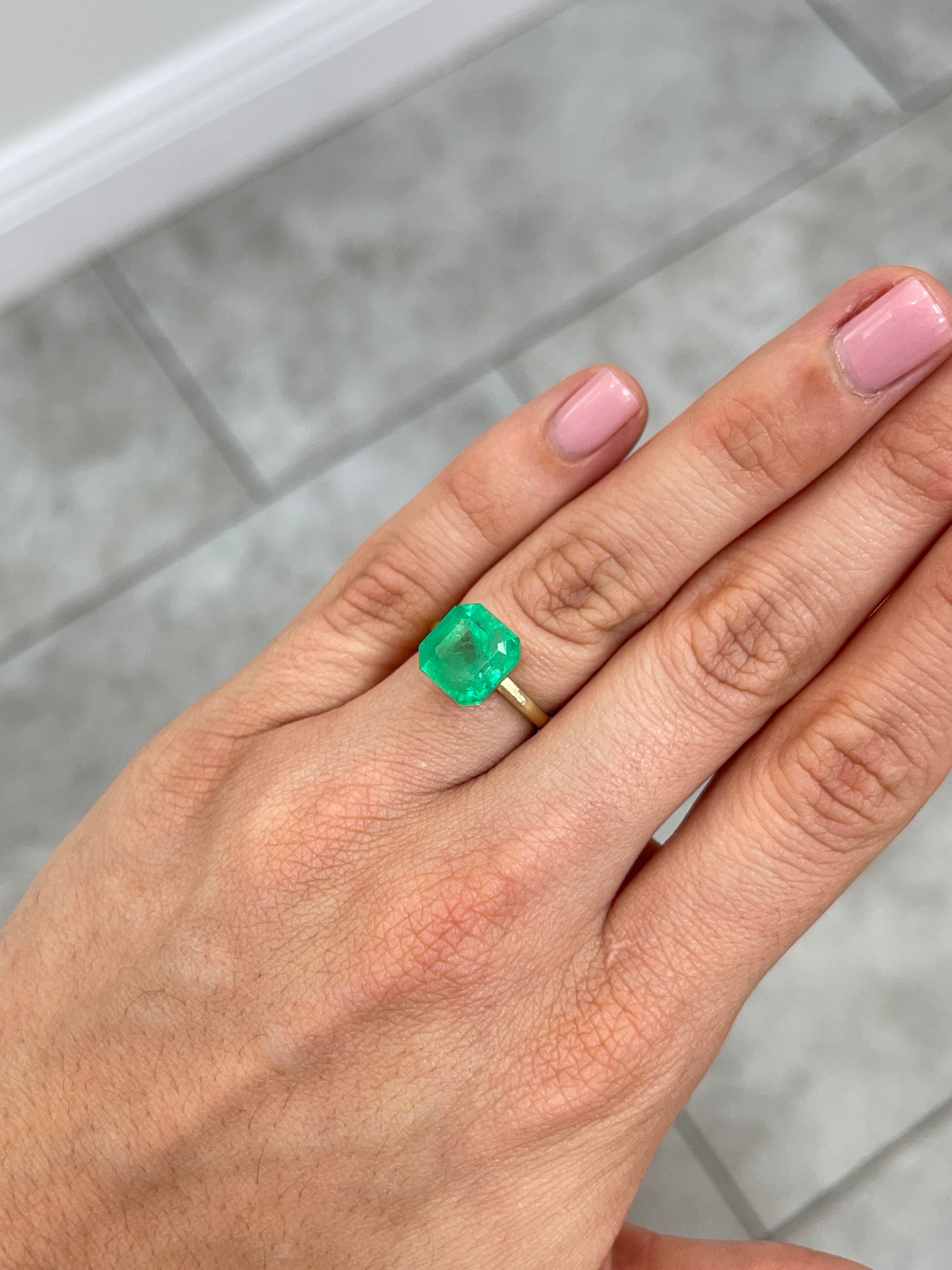 Medium neon yellowish 6.19 carat Colombian emerald loose Asscher cut from JR Colombian Emeralds, showcasing vibrant color and clarity.