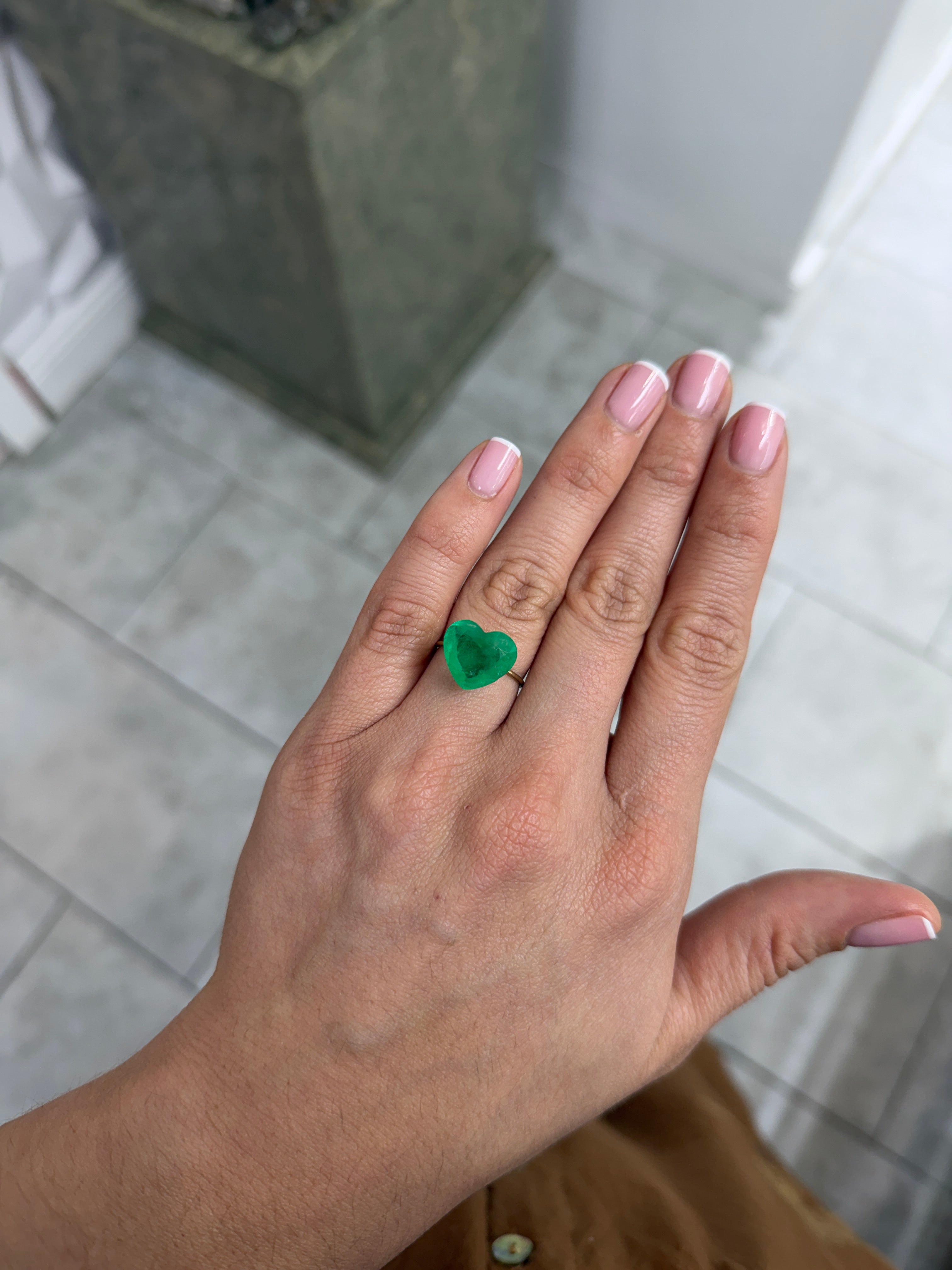 Medium green 6.35-carat Colombian emerald loose gemstone in heart cut, showcasing natural color and clarity.