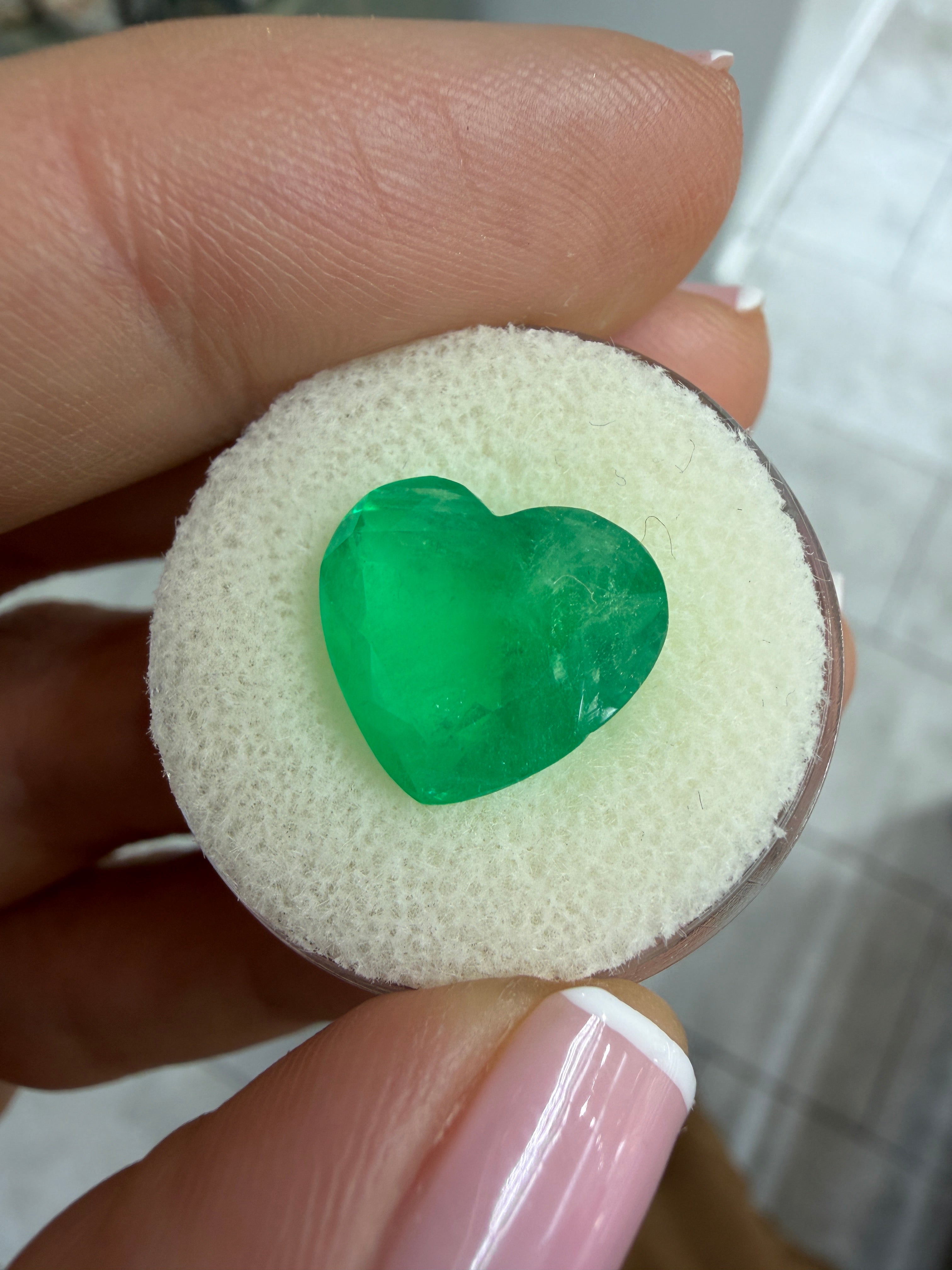 Medium green 6.35 carat Colombian emerald loose gemstone with heart cut, natural and vibrant, from JR Colombian Emeralds.
