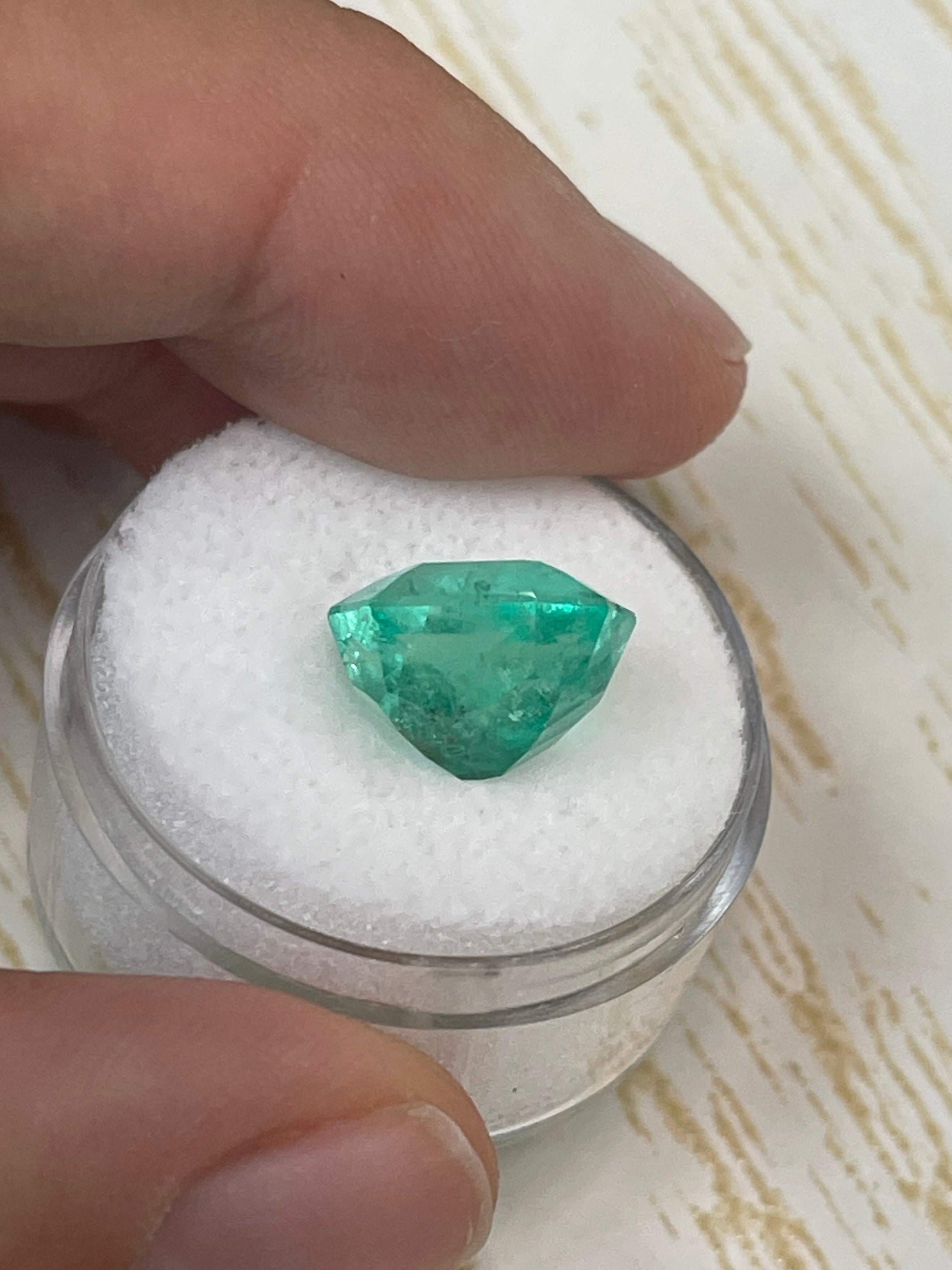 6.63 carat natural Colombian emerald loose gemstone with an 11x10mm chunky emerald cut, showcasing vibrant green color and clarity.