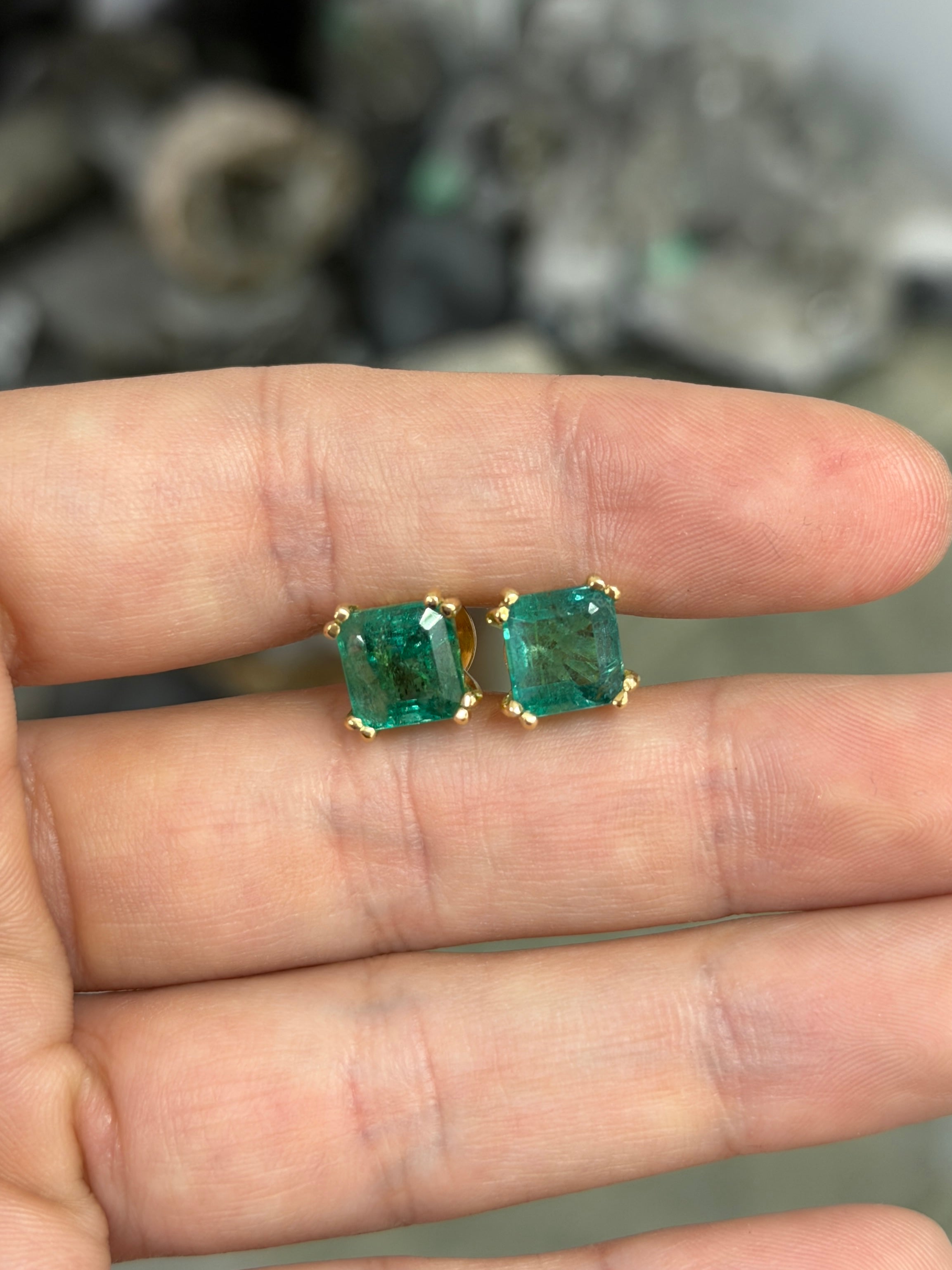 High grade 8x8mm Asscher cut natural emerald double prong stud earrings in 18K gold by JR Colombian Emeralds.