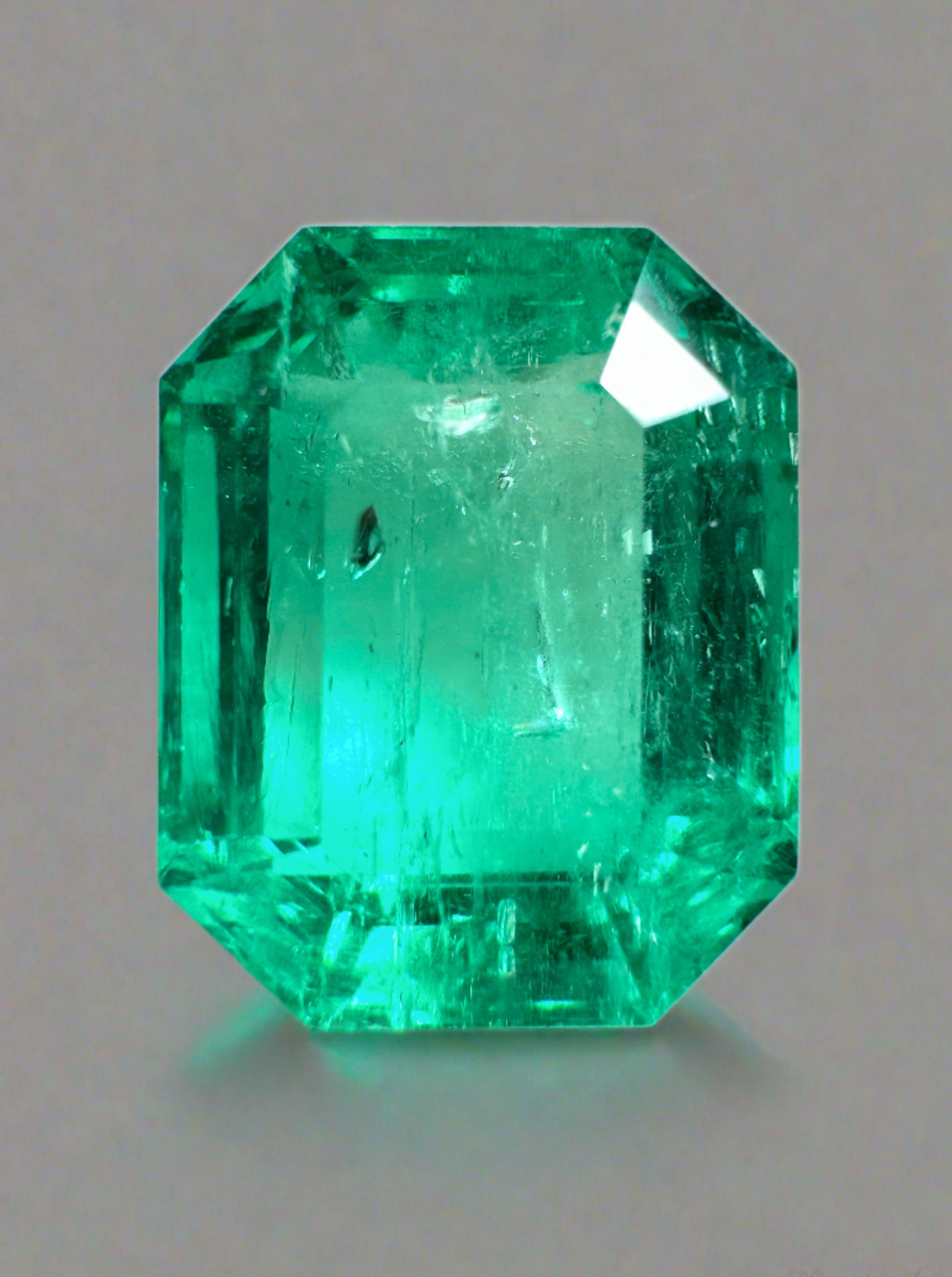 7.06 carat bluish green Colombian emerald in an emerald cut, showcasing its vibrant color and clarity, by JR Colombian Emeralds.