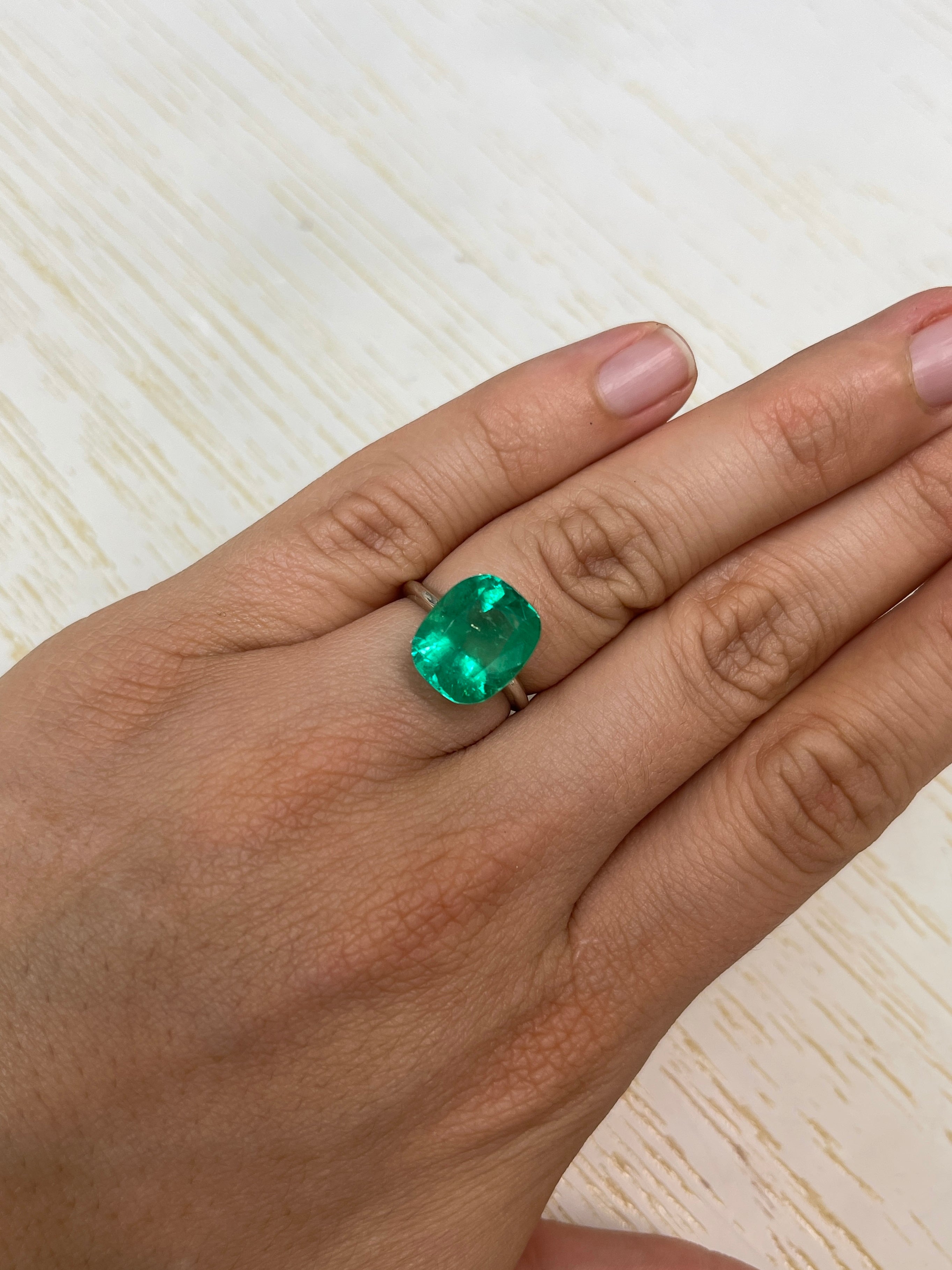 7.08 carat Muzo green Colombian emerald loose cushion cut gemstone, natural and vibrant, from JR Colombian Emeralds.