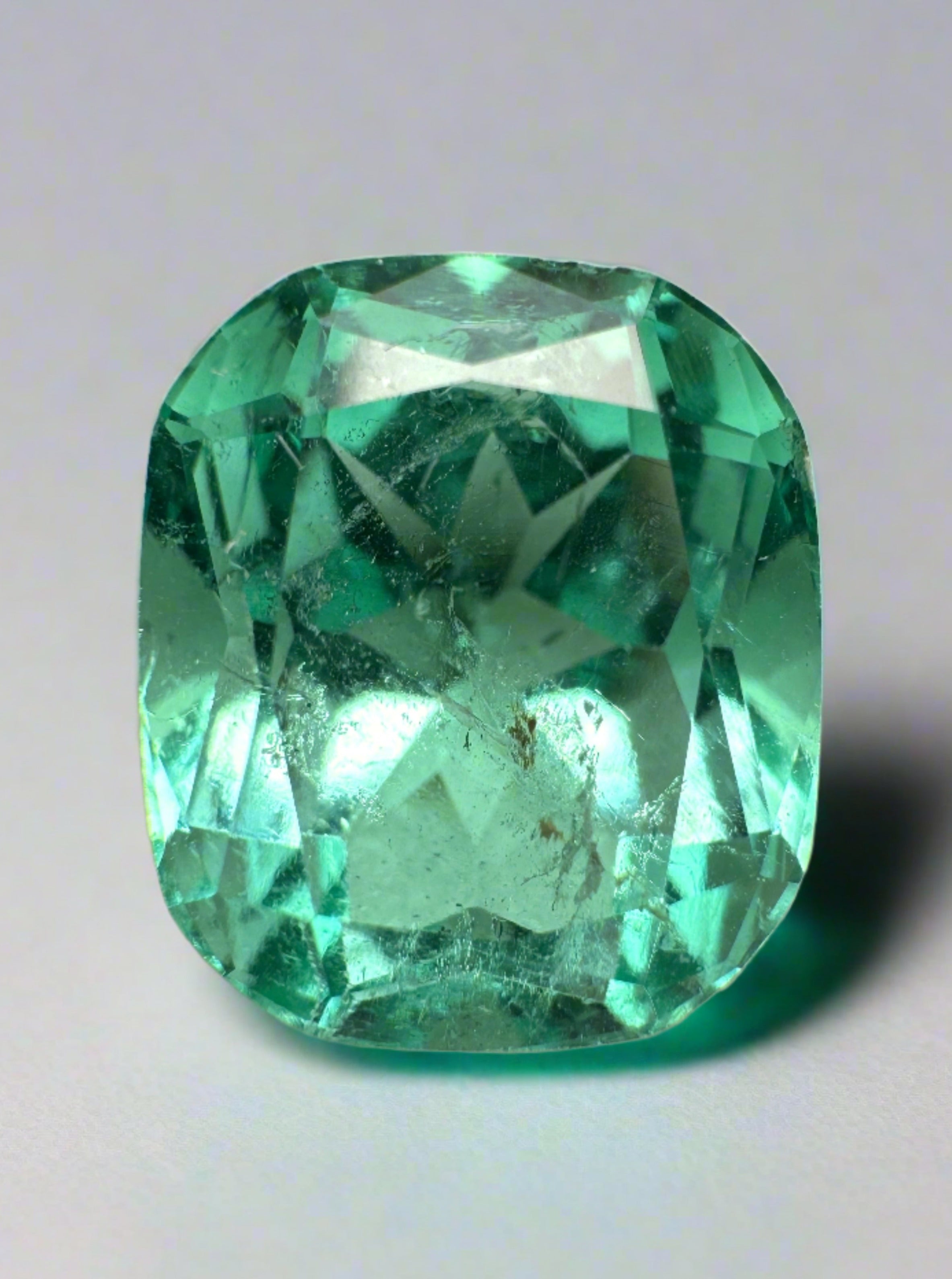 7.13 carat bluish green Colombian emerald loose cushion cut from JR Colombian Emeralds, vibrant and natural gemstone.