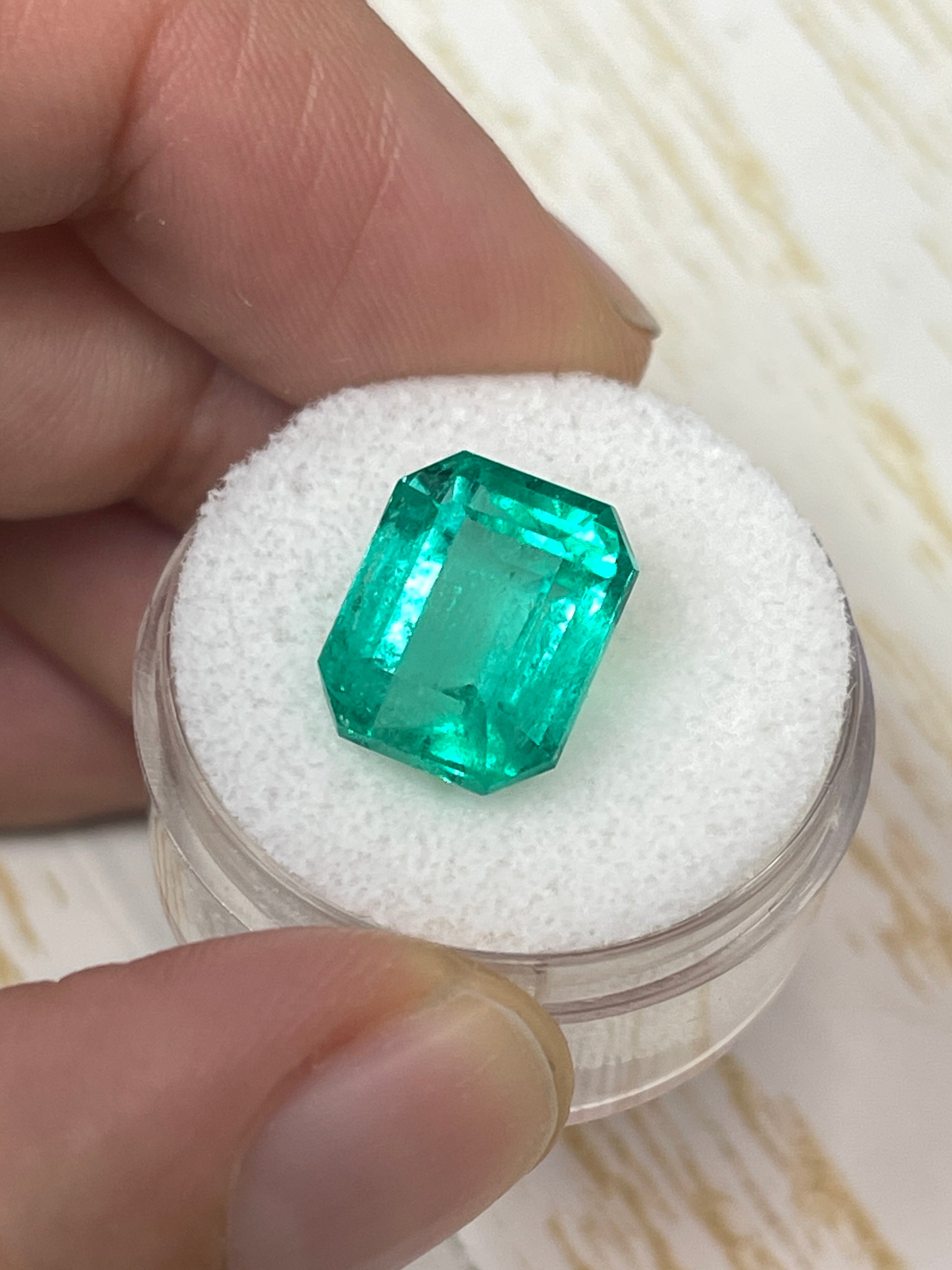 7.22 carat bluish green Colombian emerald loose gemstone in an emerald cut, showcasing vibrant color and clarity.
