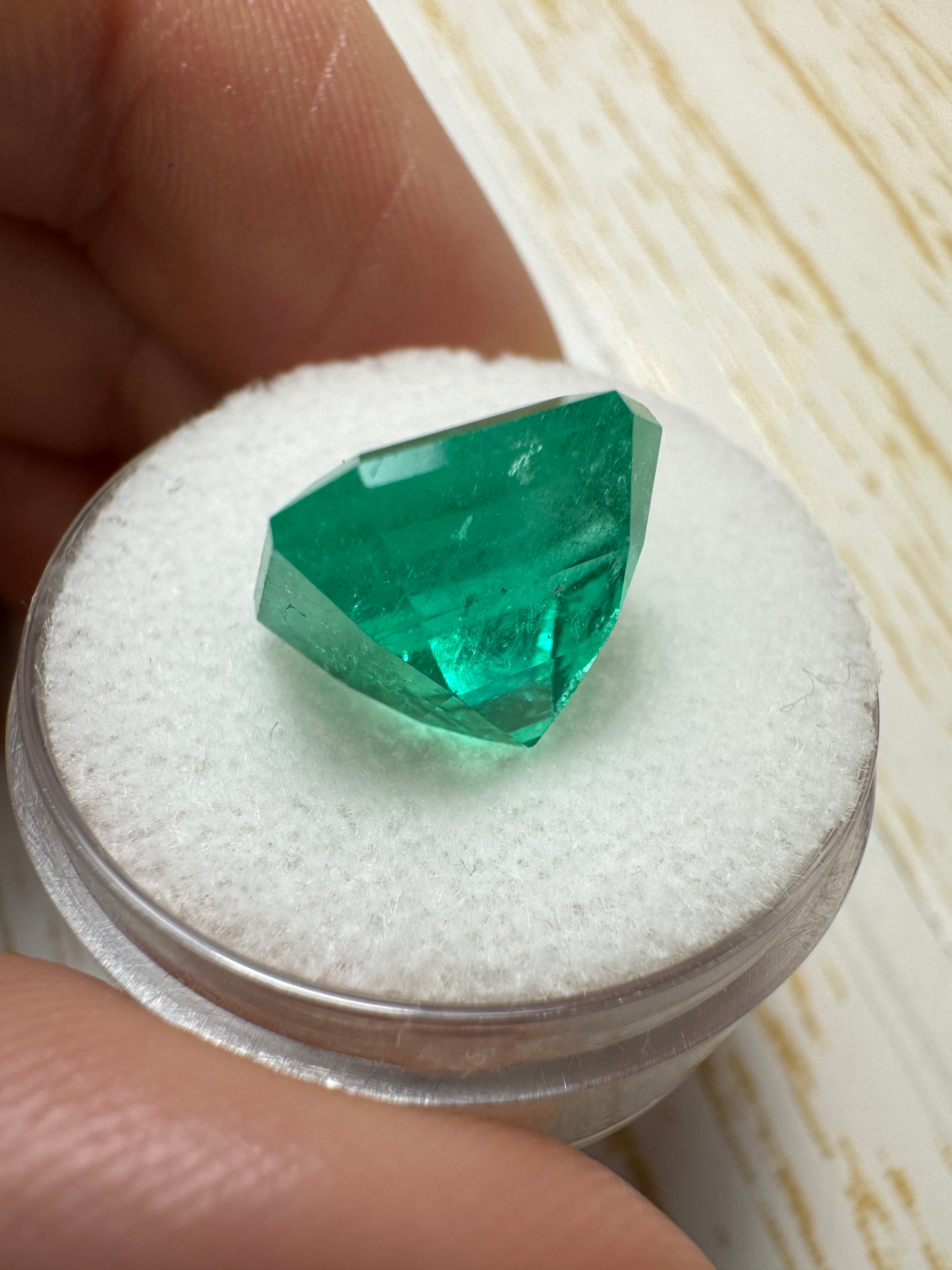 7.38 carat intense bluish green natural Colombian emerald loose Asscher cut gemstone, showcasing vibrant color and clarity.