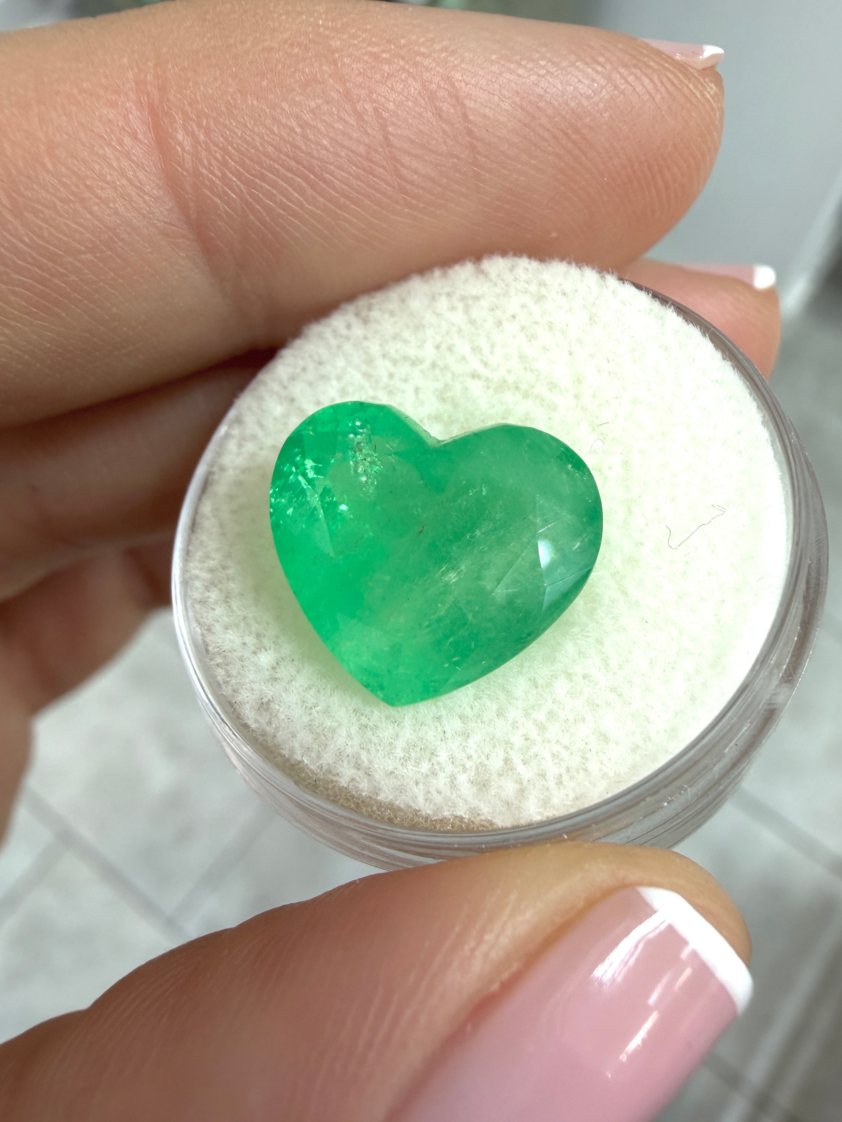 Natural 7.68 carat green Colombian emerald loose gemstone in heart cut, with earthy green hue from JR Colombian Emeralds.