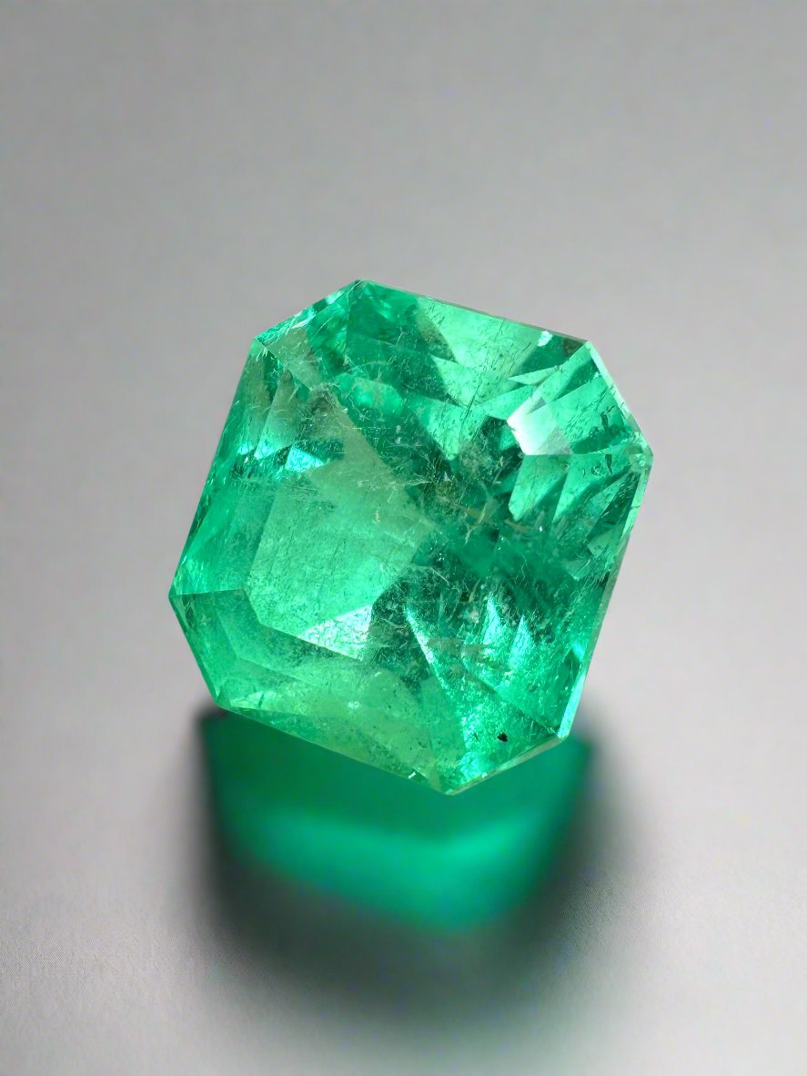 7.76 carat yellowish green natural Colombian emerald loose Asscher cut gemstone showing facets and rich color.