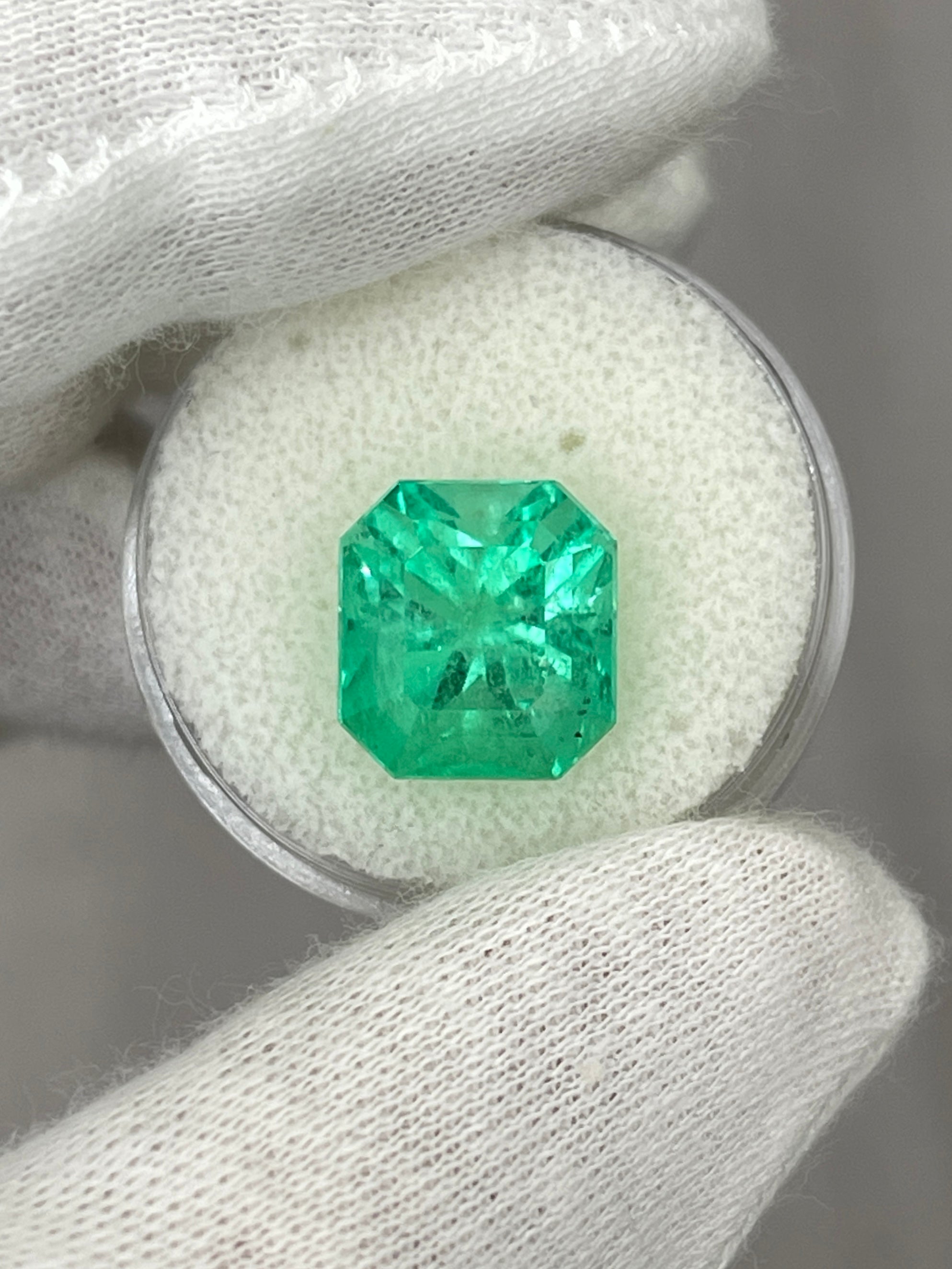 7.76 carat yellowish green natural Colombian emerald loose Asscher cut gemstone, showcasing its vibrant color and clarity.