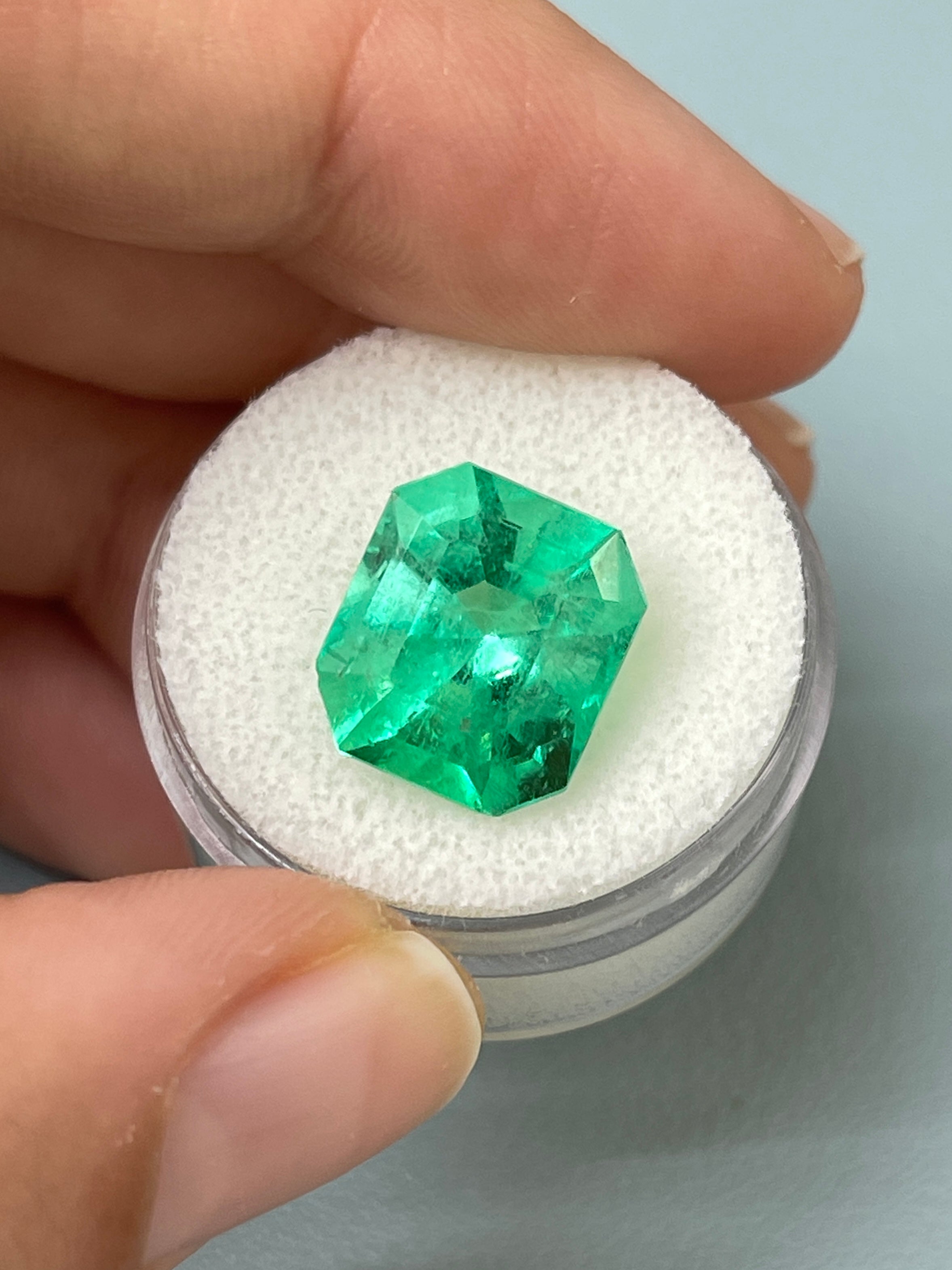 7.92 carat Colombian emerald cut loose gemstone showing a chunky 13x11.5 mm emerald shape with vibrant green color.