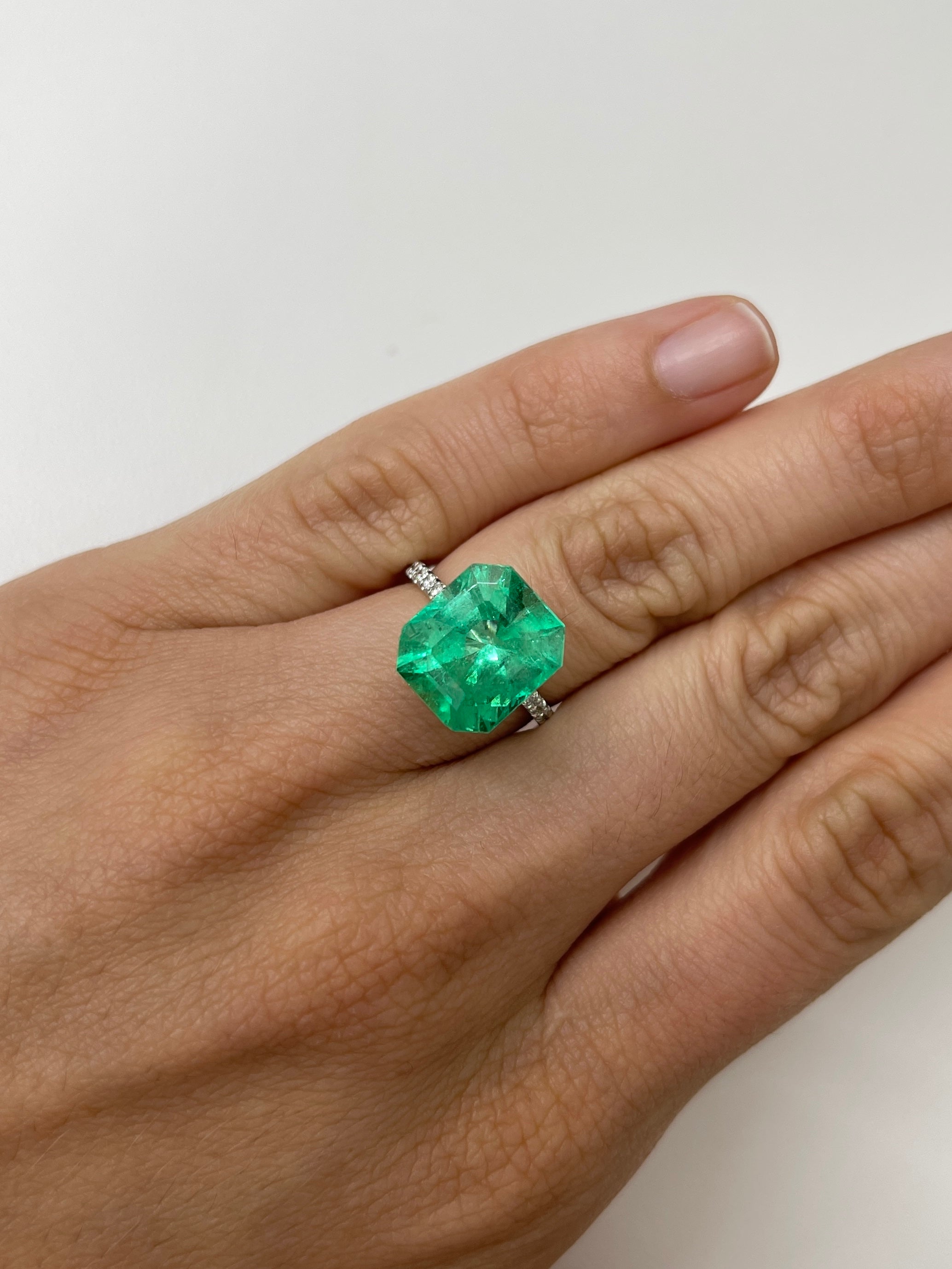 7.92 carat Colombian emerald cut loose emerald from JR Colombian Emeralds showing a chunky 13x11.5 mm rectangular gemstone with vibrant green color.