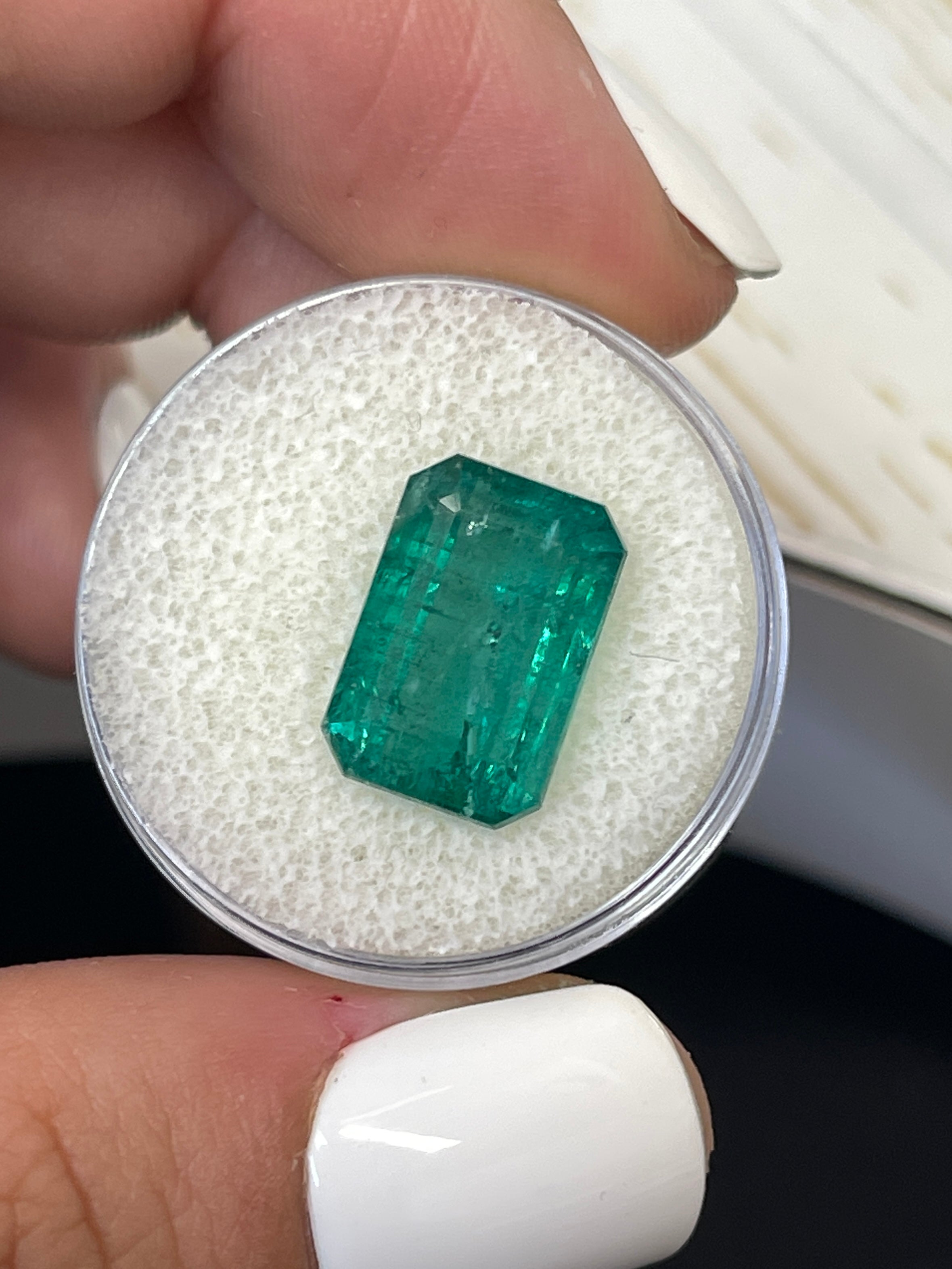 7.96 carat elongated green natural Zambian emerald cut loose gemstone by JR Colombian Emeralds.
