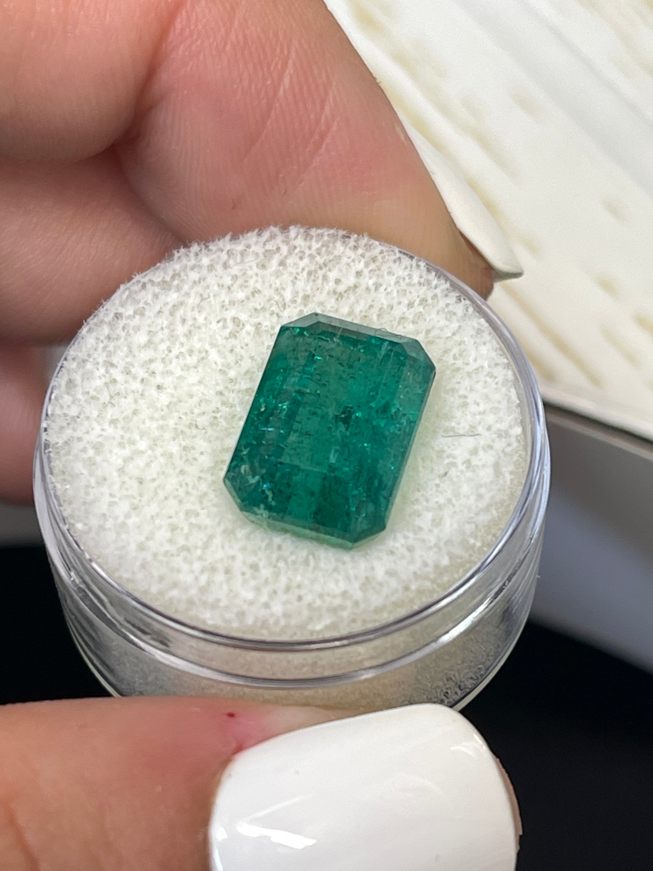 7.96 carat elongated green Zambian emerald cut loose gemstone from JR Colombian Emeralds, natural and vibrant in appearance.