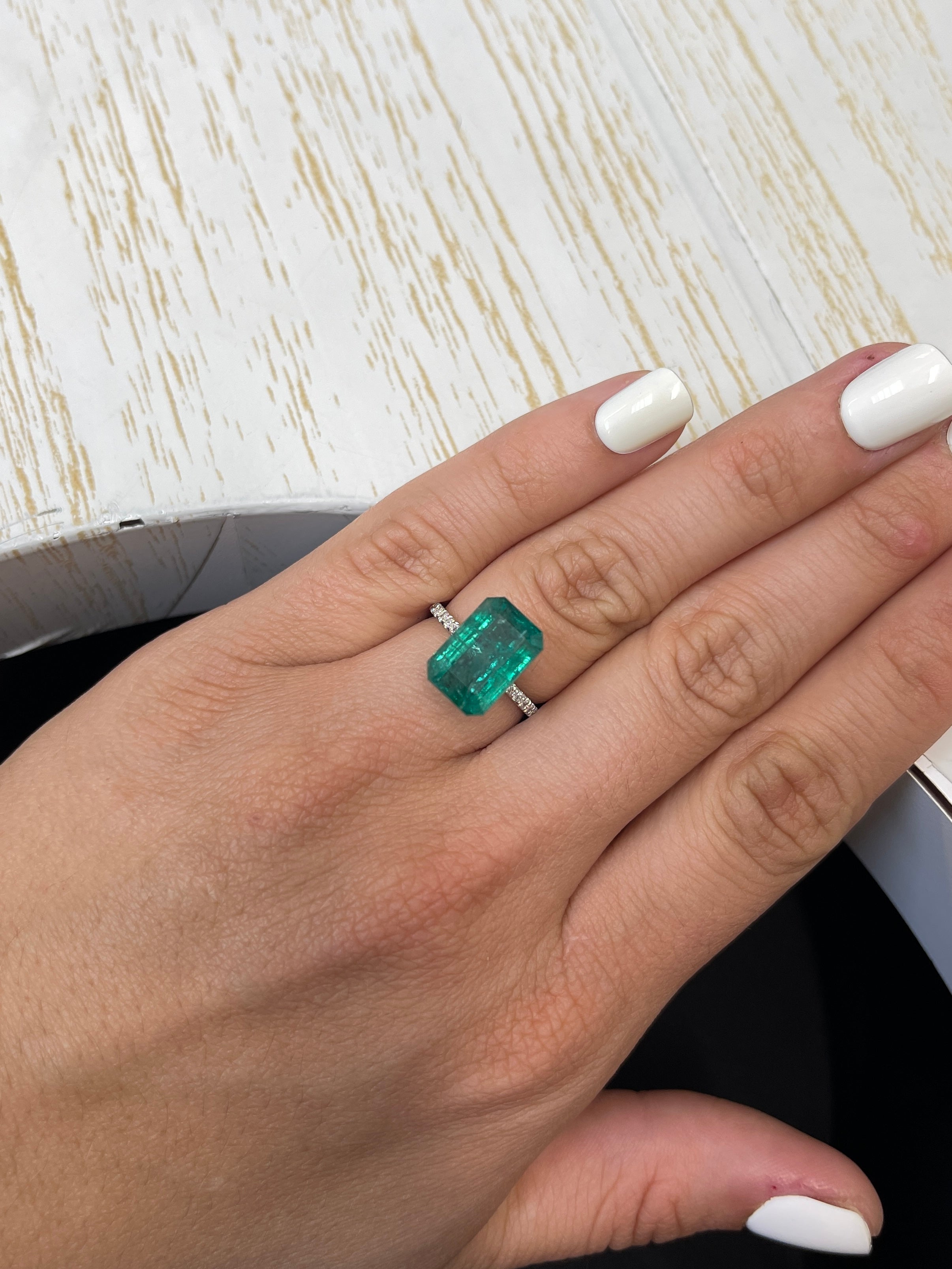 7.96 carat elongated green Zambian emerald cut loose gemstone from JR Colombian Emeralds with natural clarity and vibrant color