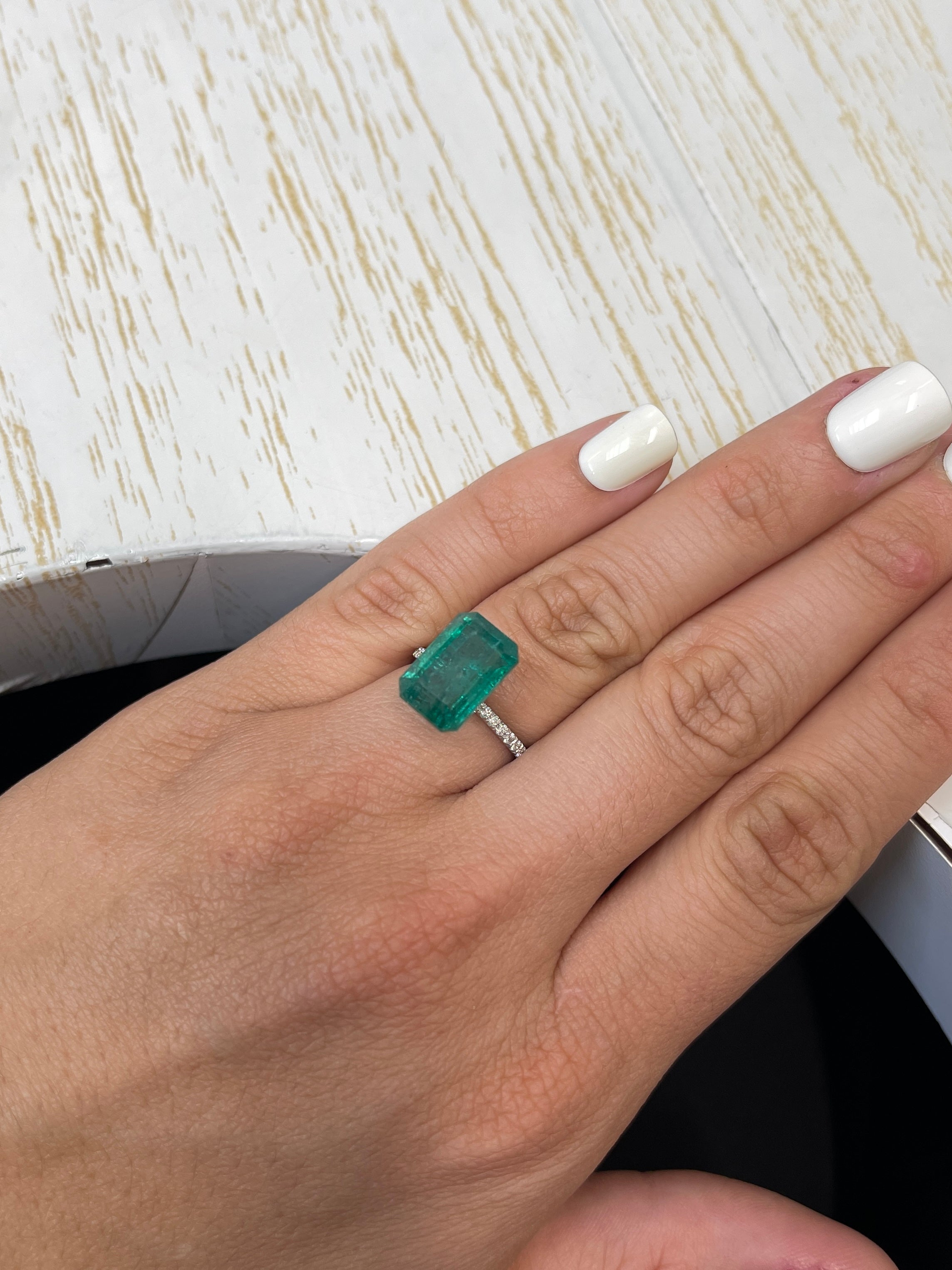 7.96-carat elongated 14x9 mm natural green Zambian emerald cut loose gemstone from JR Colombian Emeralds.