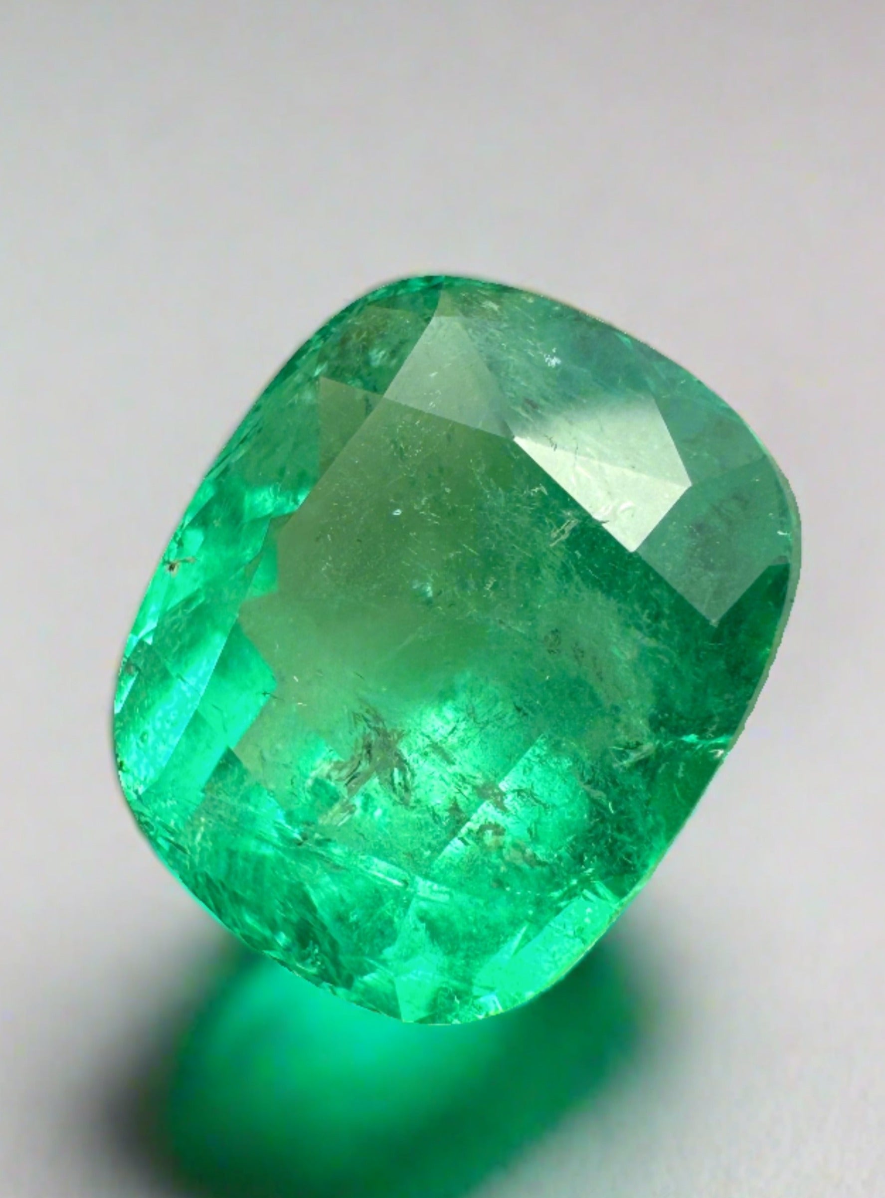 8.04 carat yellowish green natural Colombian emerald in cushion cut, loose gemstone with vibrant color and clarity.