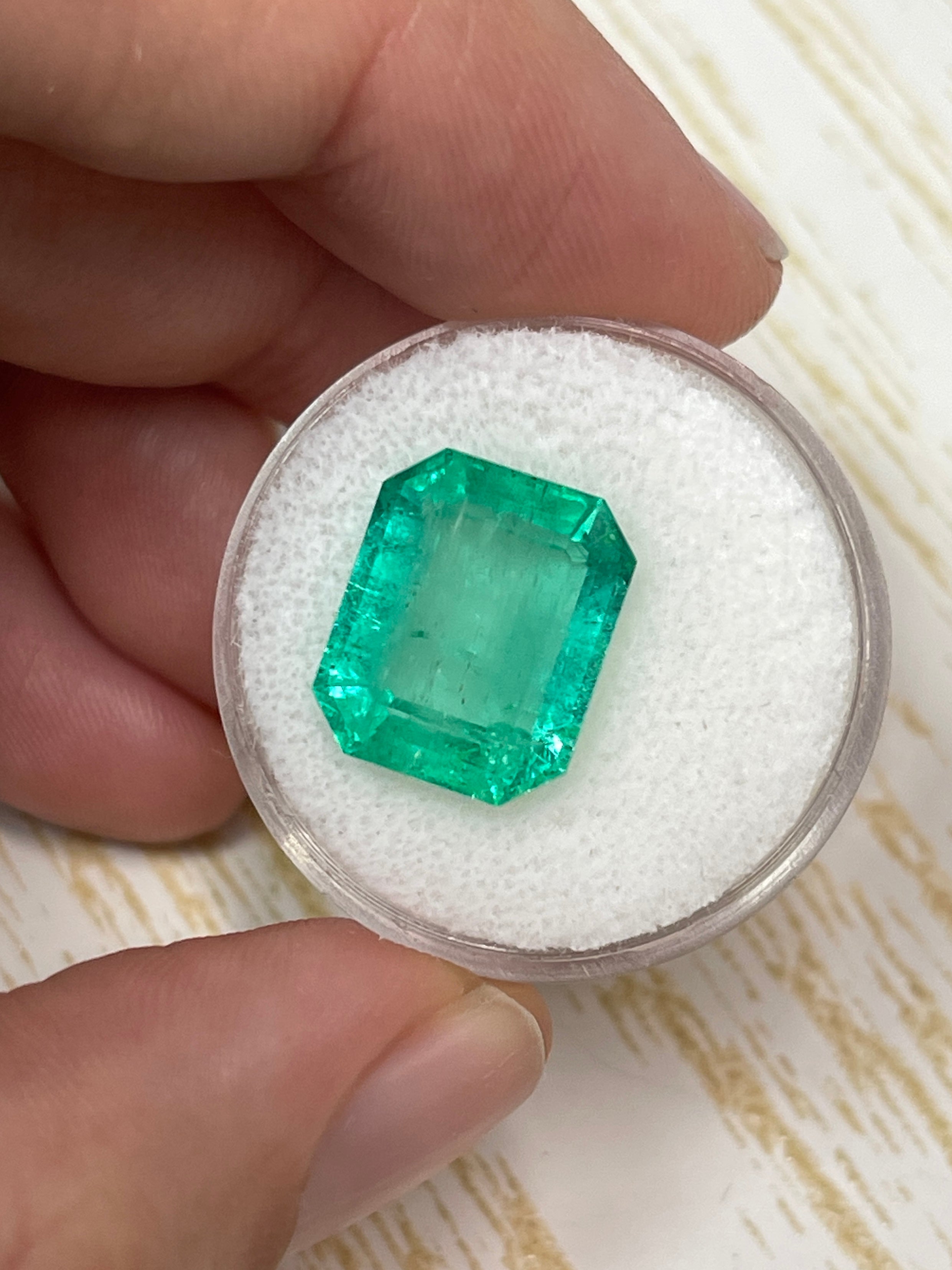 Medium green 8.20 carat emerald cut loose Colombian emerald by JR Colombian Emeralds, showcasing its clarity and vibrant color.