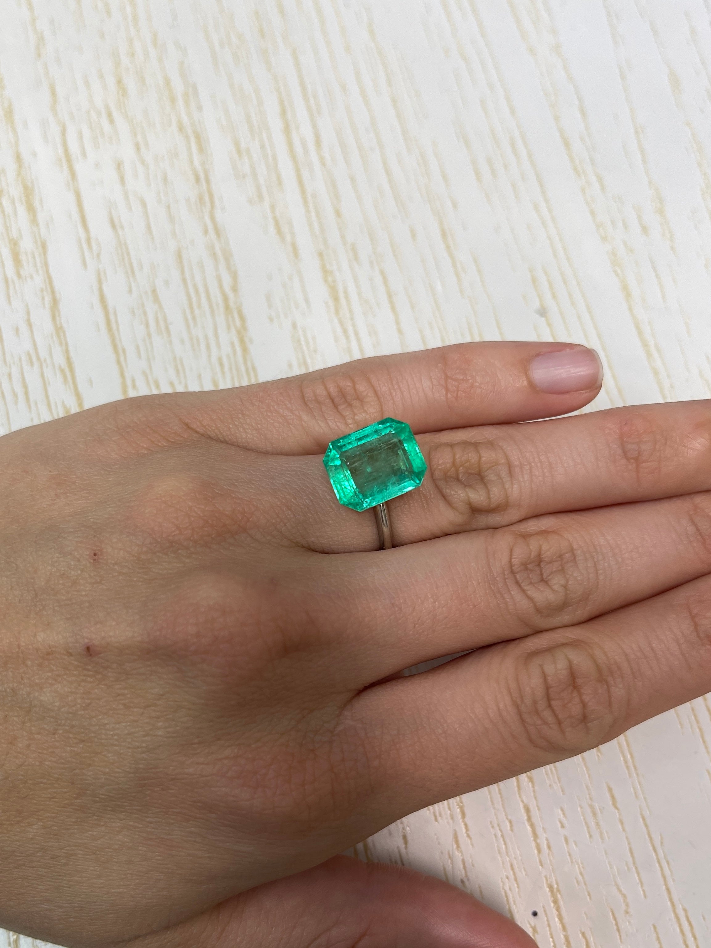 8.20 carat medium green Colombian emerald cut loose gemstone from JR Colombian Emeralds, showcasing its vibrant color and clarity.