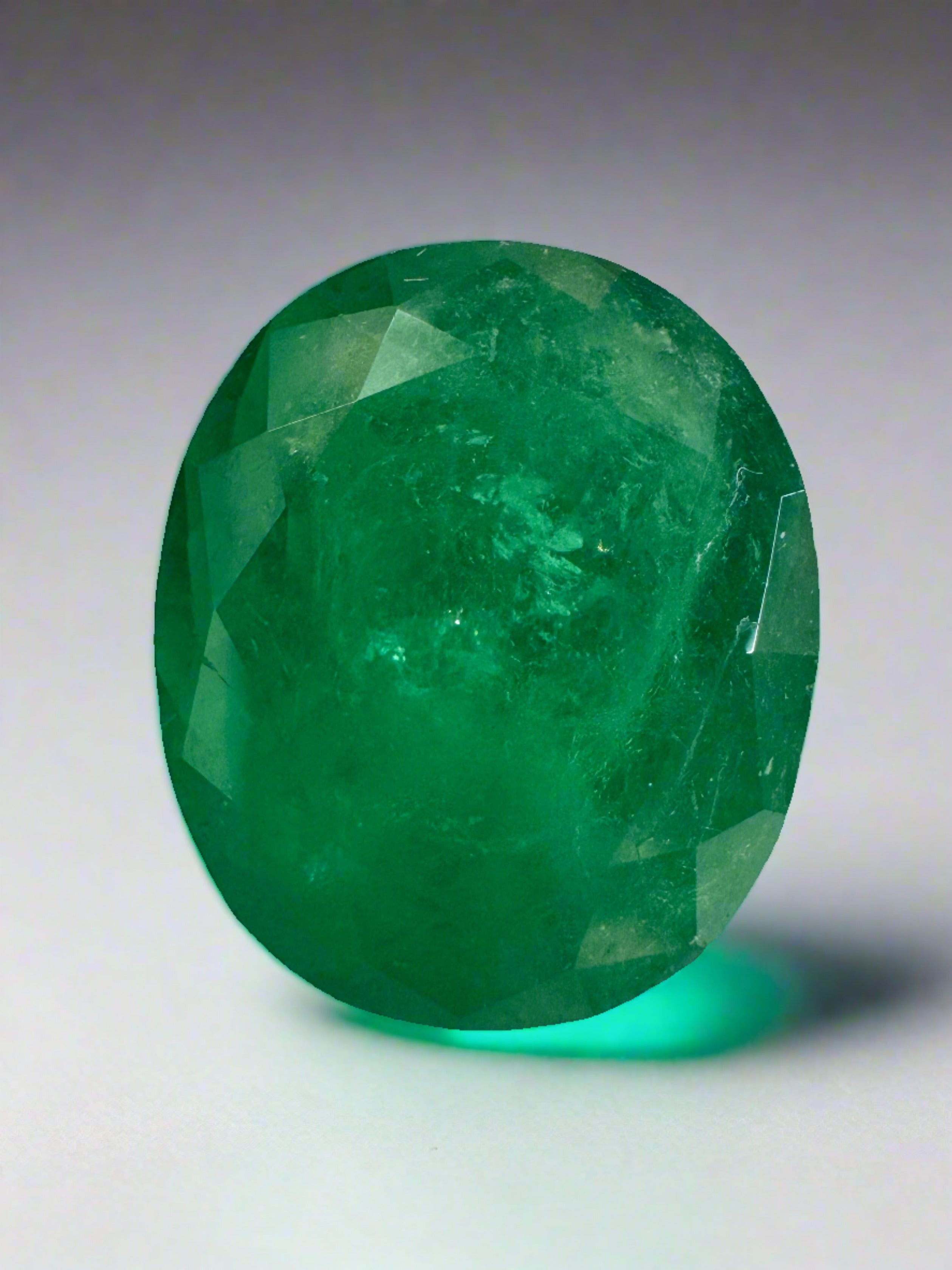 Deep green 8.29 carat oval cut Colombian emerald loose gemstone from JR Colombian Emeralds. Natural, richly colored emerald.