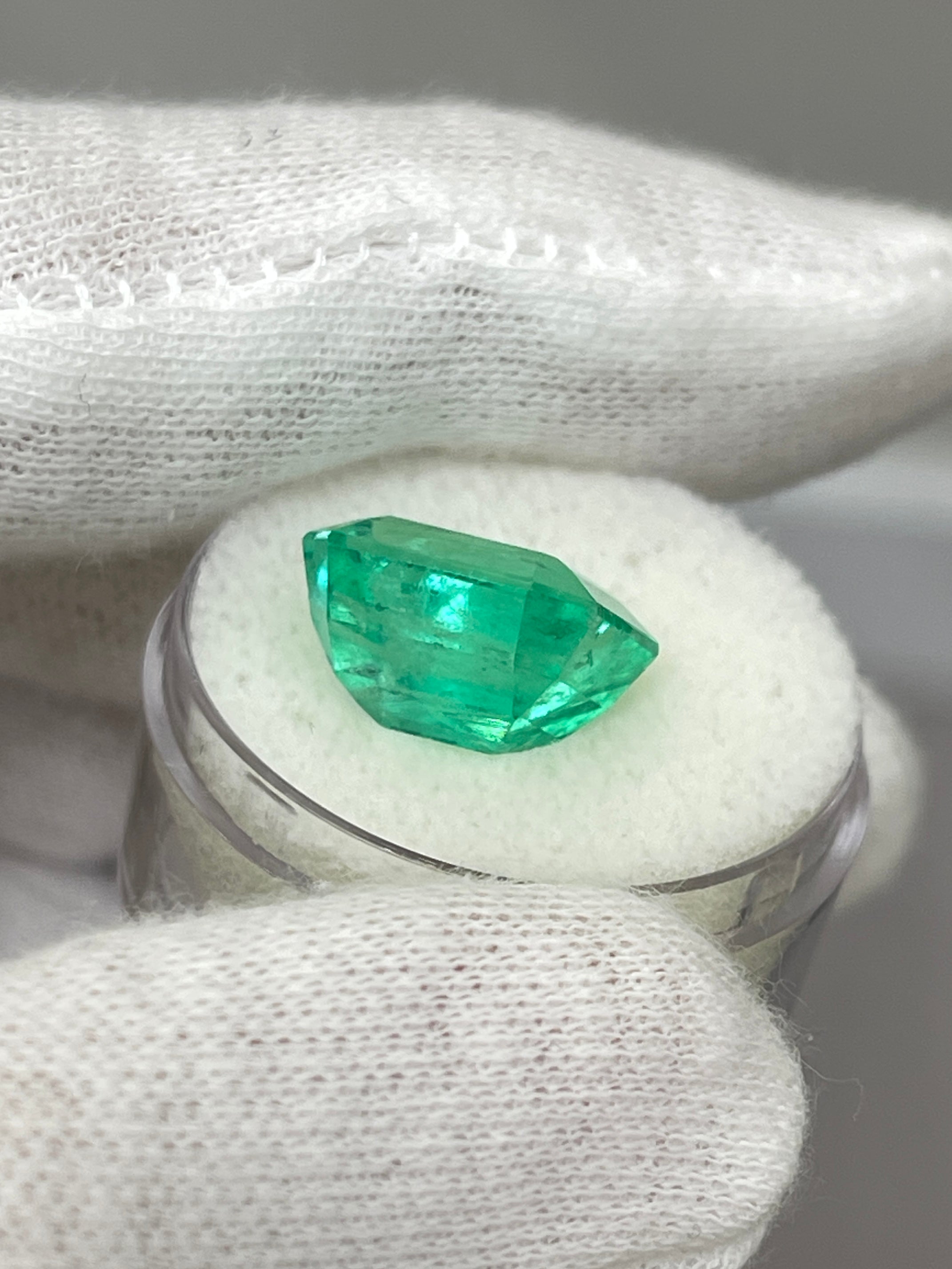 8.33 carat Colombian emerald cut loose emerald from JR Colombian Emeralds, showcasing a crystal-clear, vibrant green gemstone.