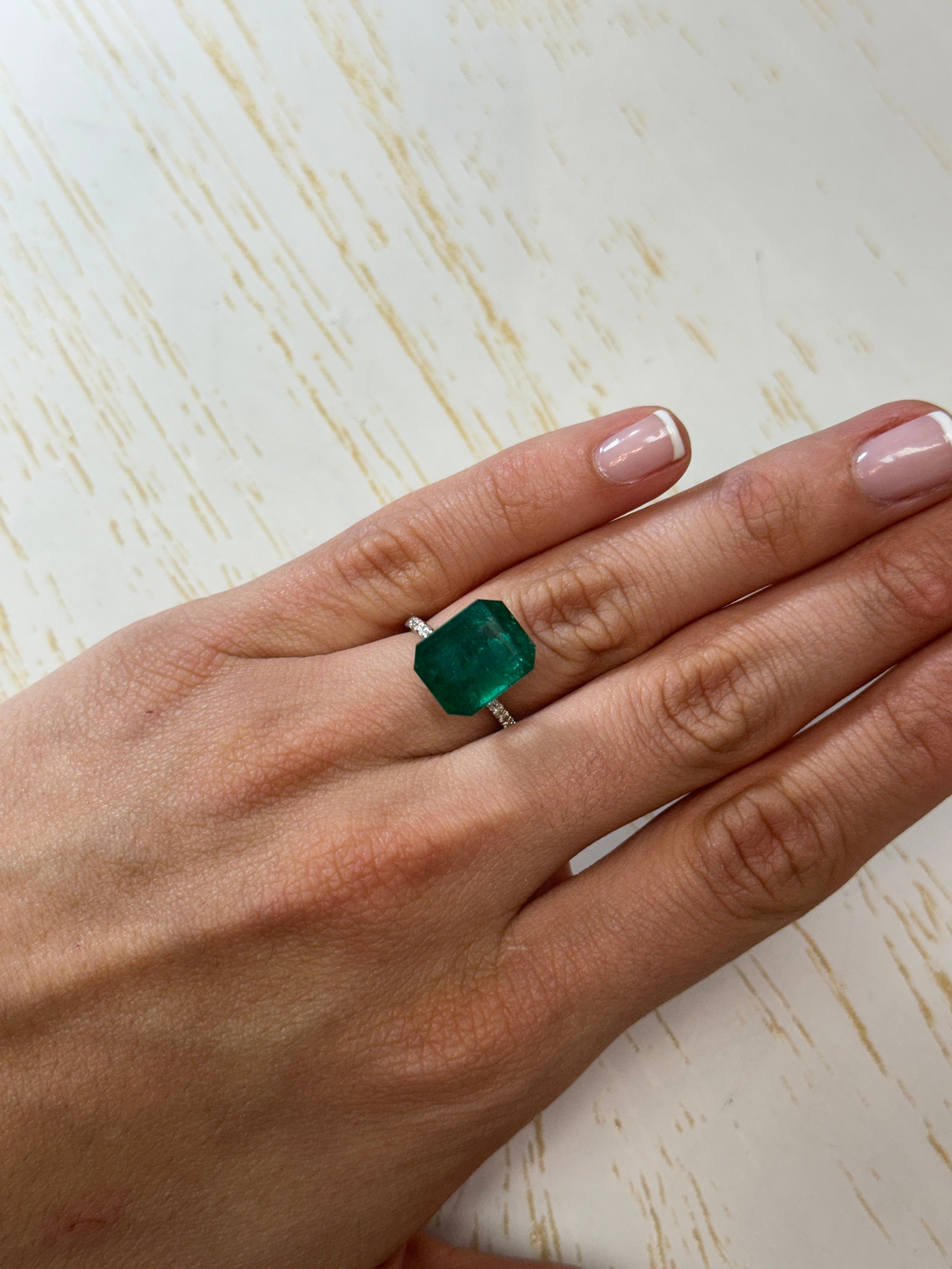Deep green 8.60 carat Zambian emerald cut loose gemstone, shown in a 13.5x11 mm shape from JR Colombian Emeralds.