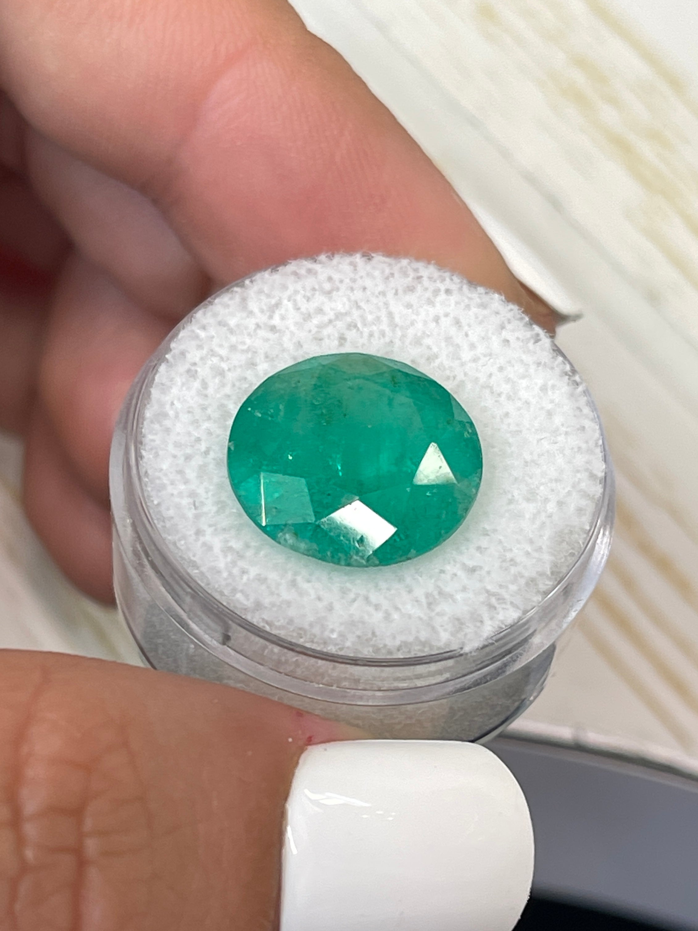 Deep green 8.80 carat round Colombian emerald loose gemstone with natural clarity and vibrant color.
