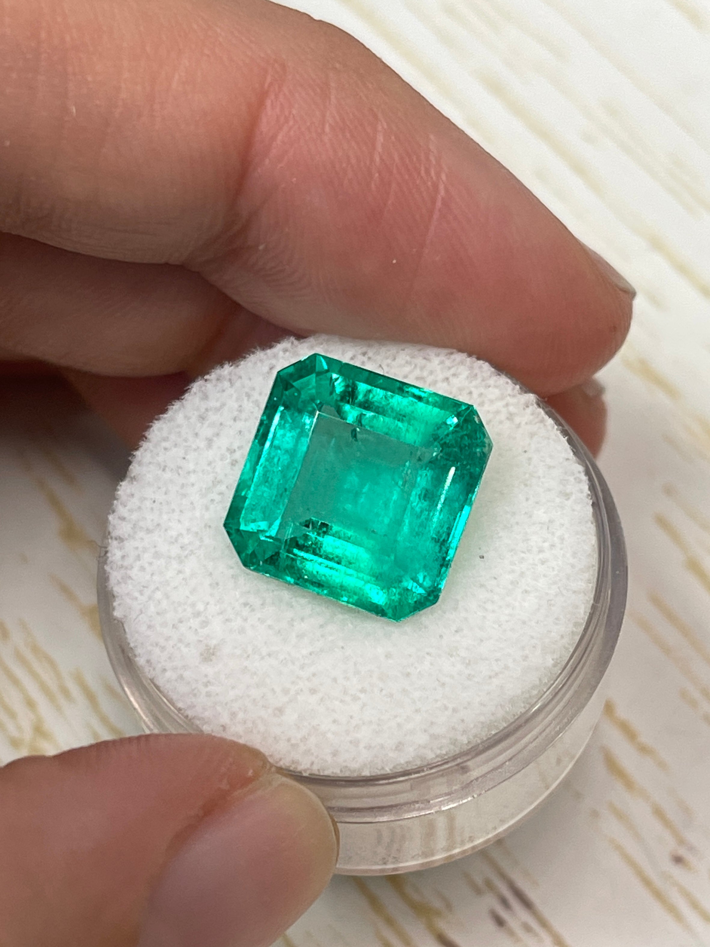 8.81 carat glowing green natural Colombian emerald loose Asscher cut gemstone with vibrant color and clarity.