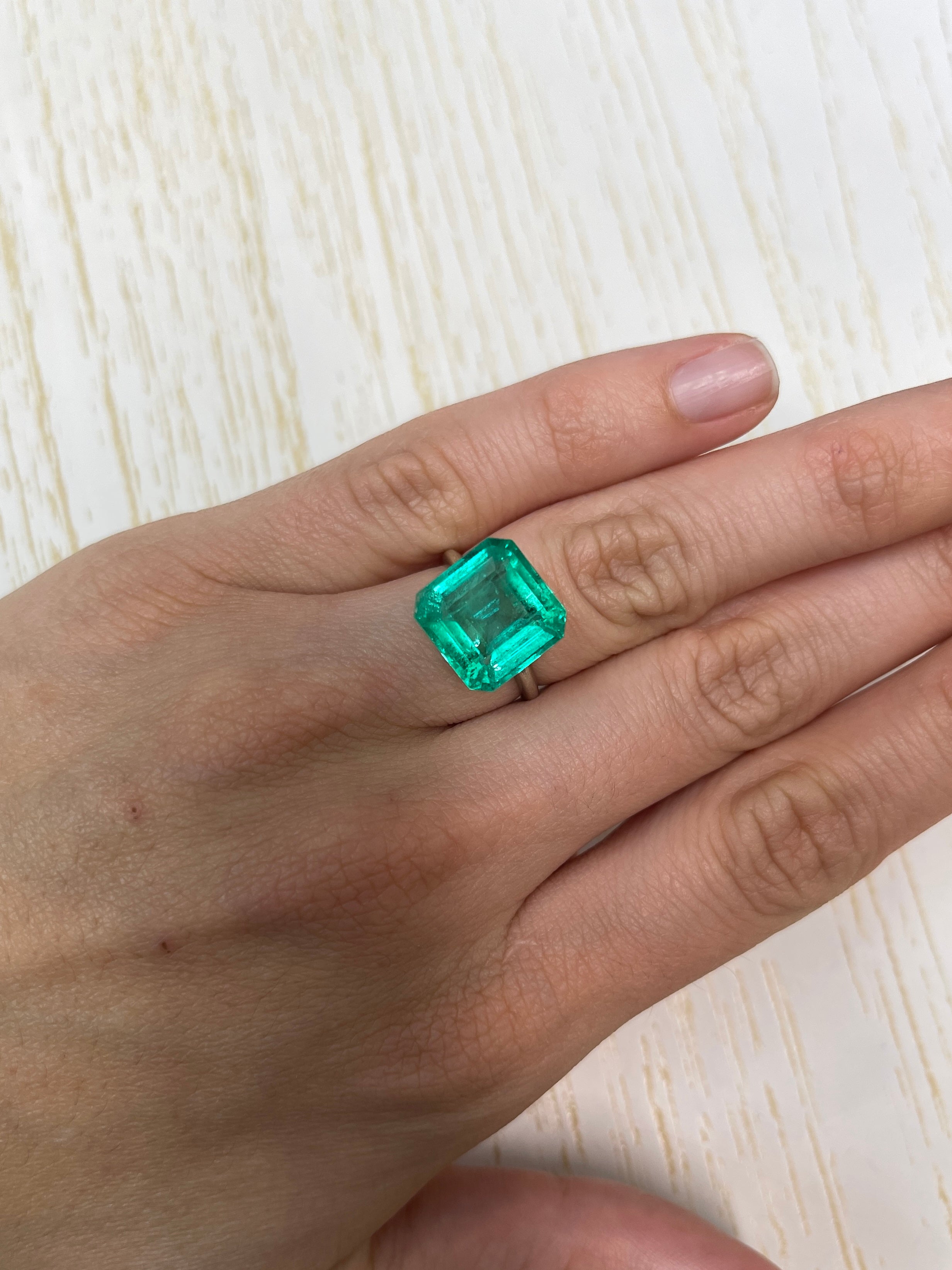 8.81 carat glowing green natural Colombian emerald loose gemstone in Asscher cut, showcasing vibrant color and clarity.