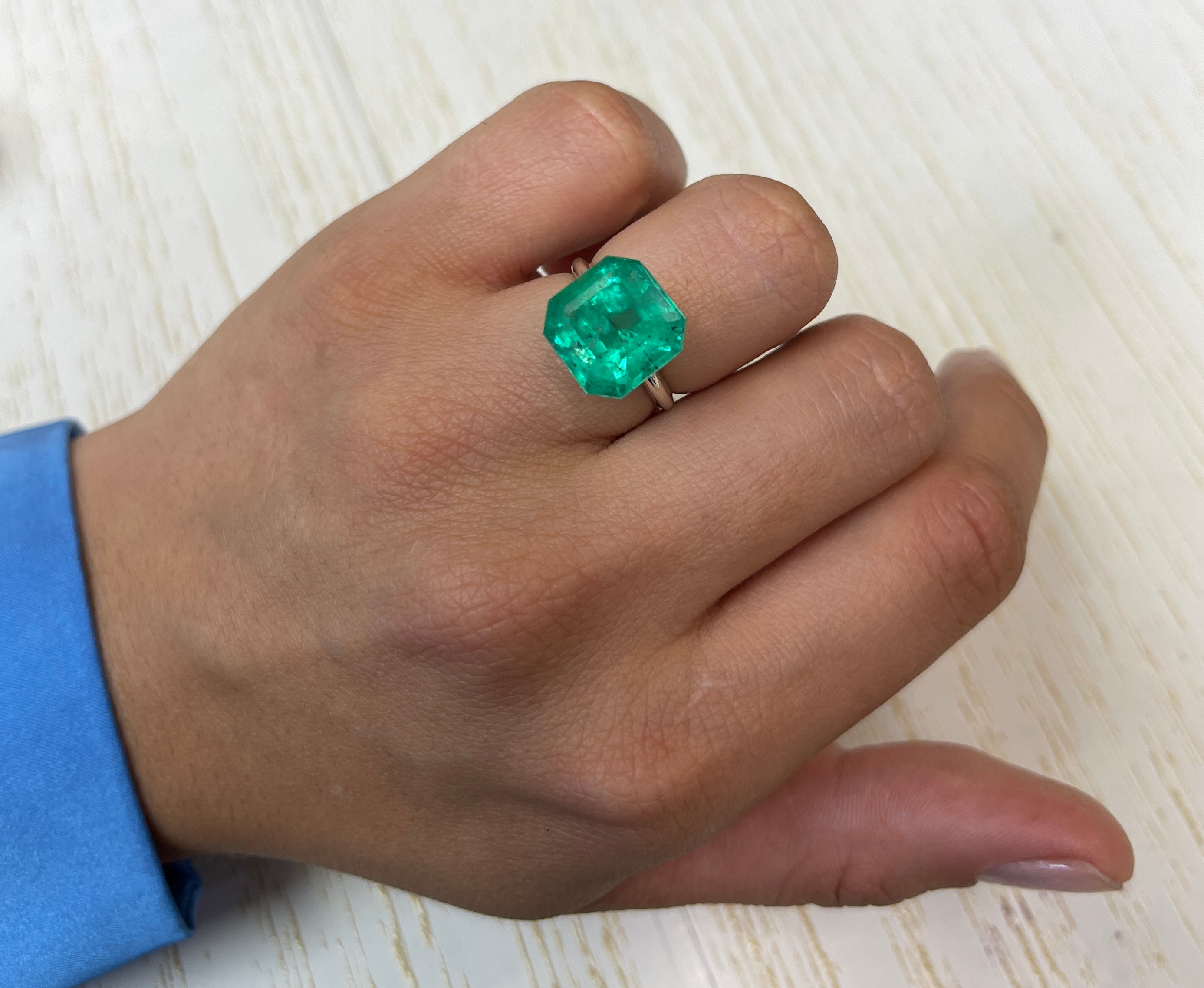 Large 9.03 carat green Colombian emerald in Asscher cut, natural loose gemstone with vibrant color and clarity.