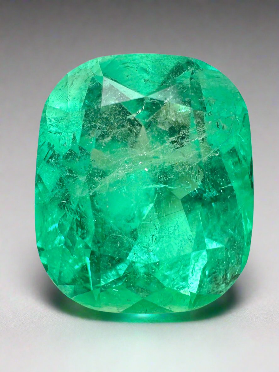9.23 Carat Muzo yellowish green Colombian emerald loose cushion cut from JR Colombian Emeralds, natural and vibrant gemstone.